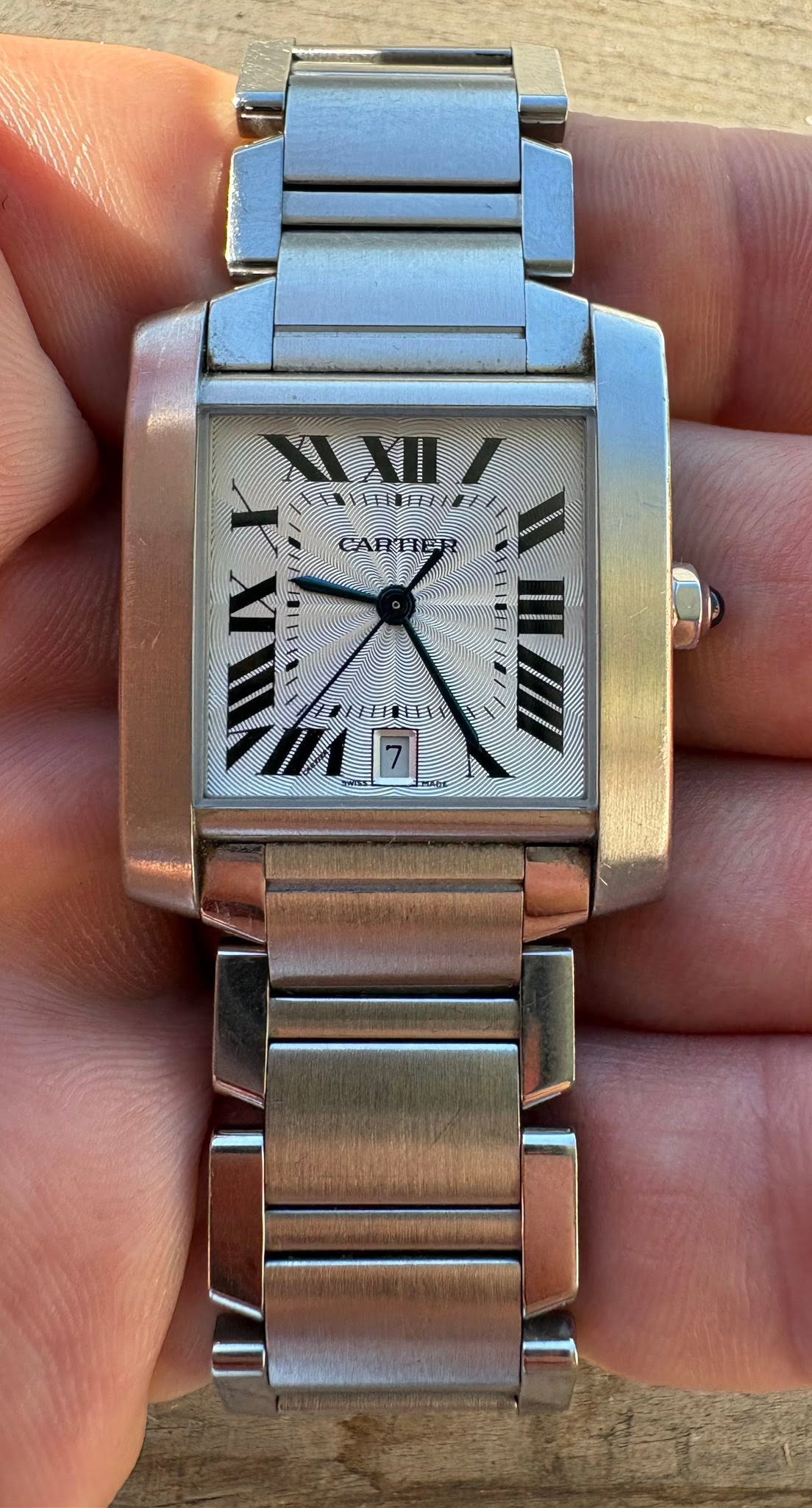 May be an image of wrist watch and text