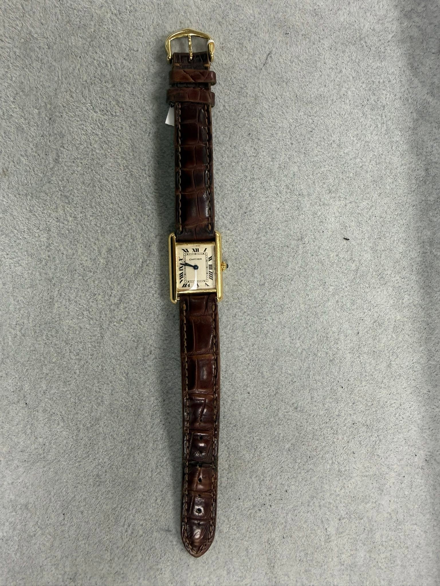 May be an image of saddle-stitched leather, leather and wrist watch