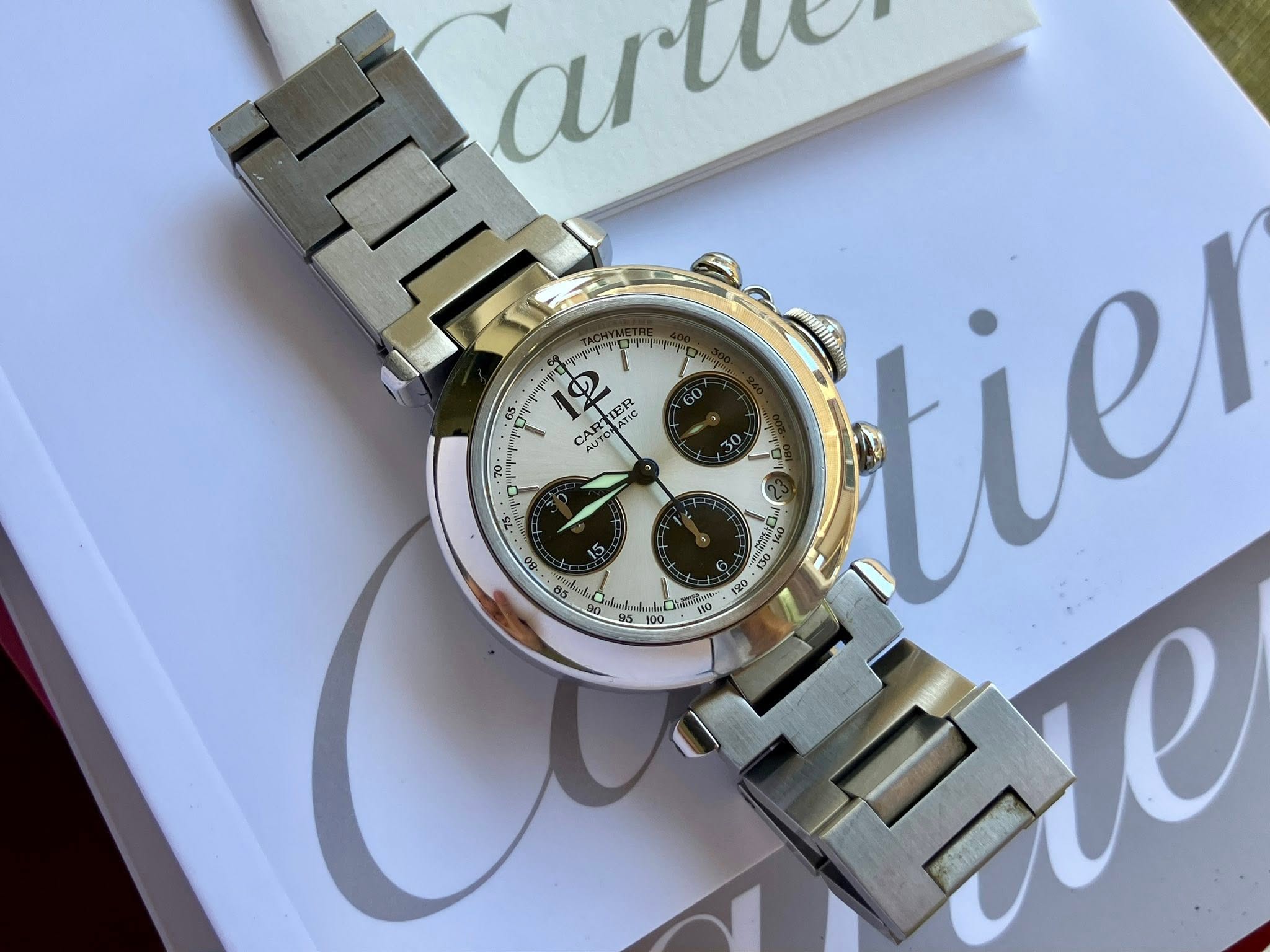 May be an image of wrist watch and text that says '65 2 TER ATIC CART AUTO AR AUTONA AUTO 20 50 t 100 art me tiel 110'