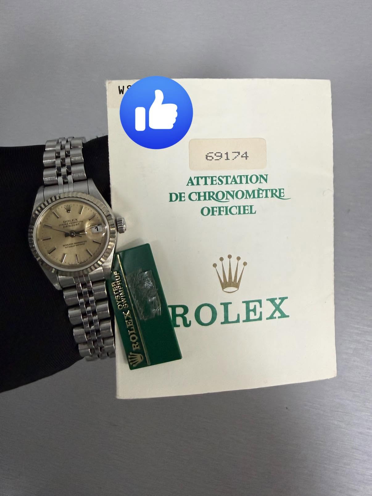 May be an image of wrist watch and text that says 'W h 59174 ATTESTATION DE CHRONOMETRE OFFICIEL ROLEX RO EX'