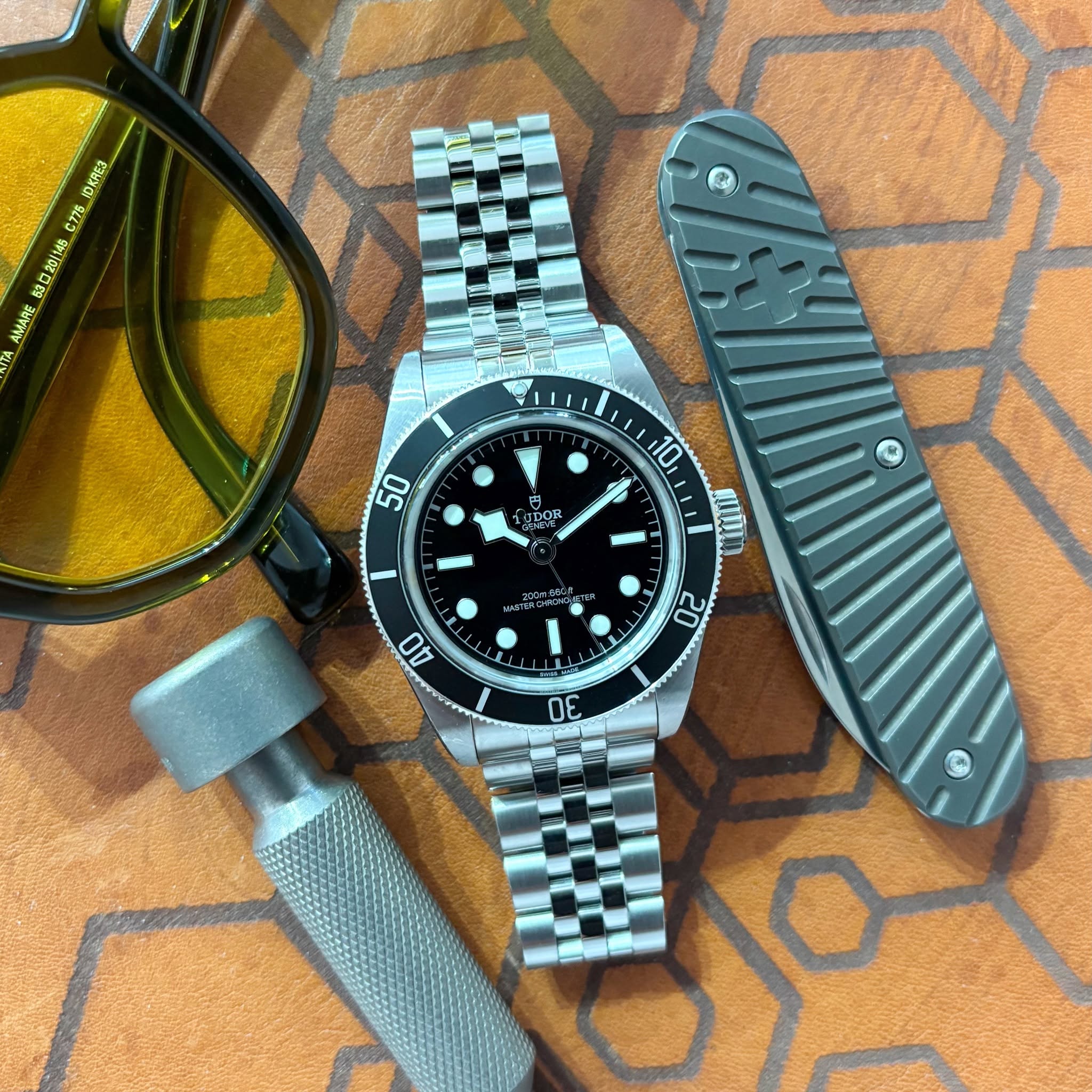 May be an image of knife, wrist watch and text