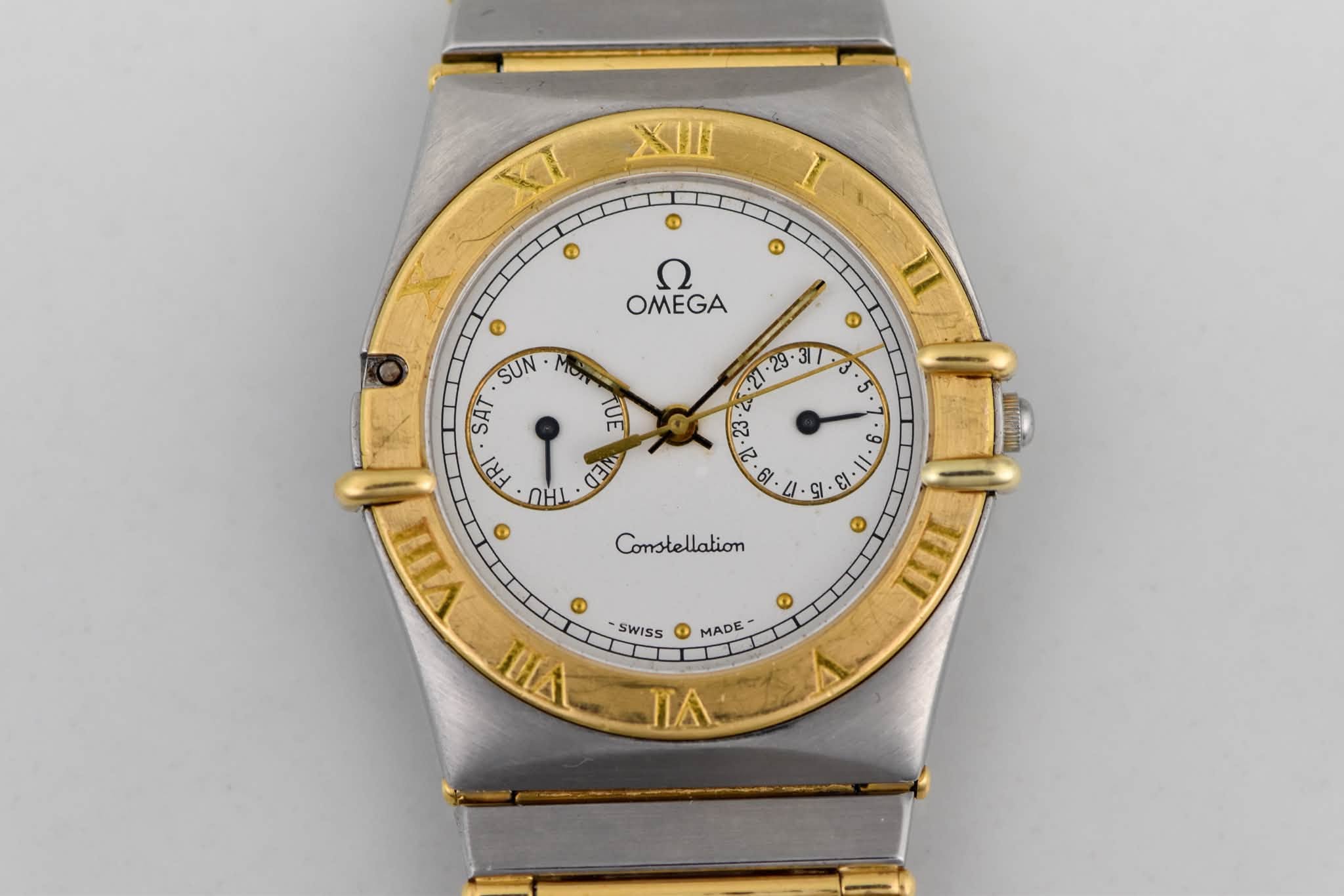 May be an image of wrist watch and text that says 'XIIII a ® ១ ® Ω OMEGA 1I ® . U : م 13 ခ SUN MOI SAT TUE FRI m OHI G VITT ® 医 ትማ SWISS O MADE ΠΑ S Constellation ® THI ®'