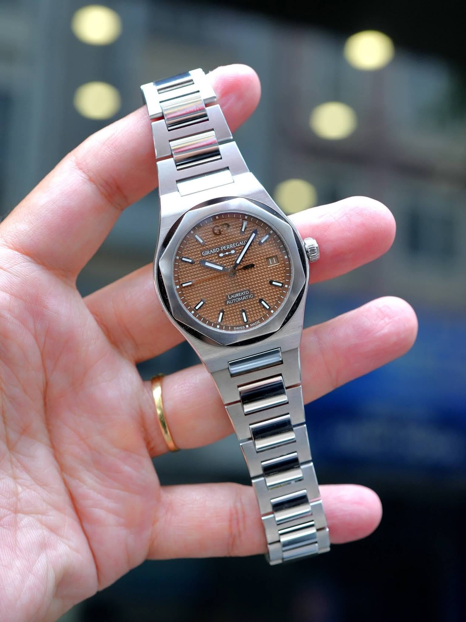 May be an image of wrist watch and text