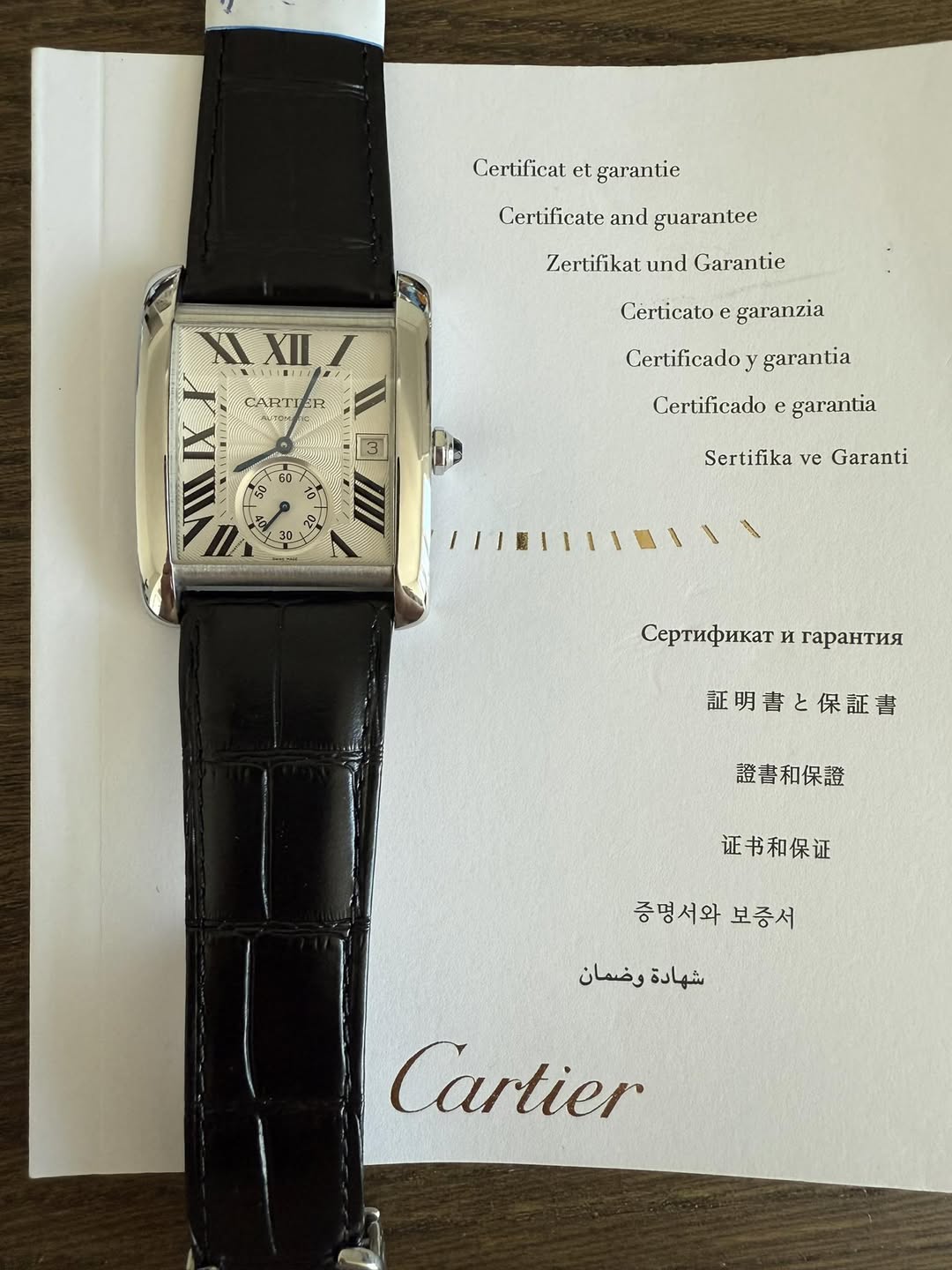 May be an image of wrist watch and text that says 'Certificat et garantie Cerlificate and guarantee Zertifikat und Garantie XIXIII XII CARTIER Certicato garanzia Certificado…