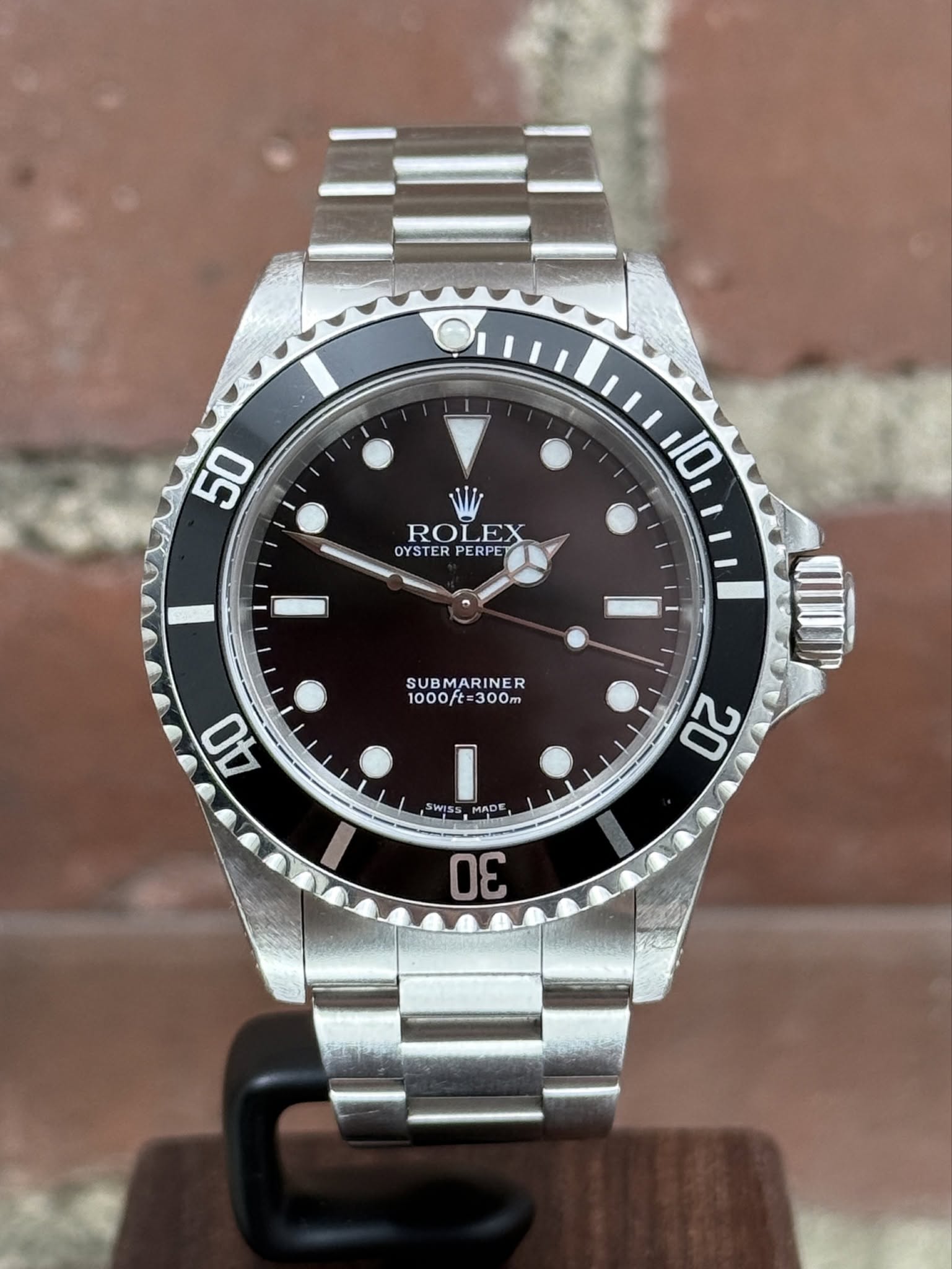May be an image of wrist watch and text that says '50 RO ROLEX EX OYSTER OYSTERPERPET PERPE 10 SUB SUBMARINER 1000/t=300m 300m 1000ft 40 SWISS ISS MADE 20 30 apAH'