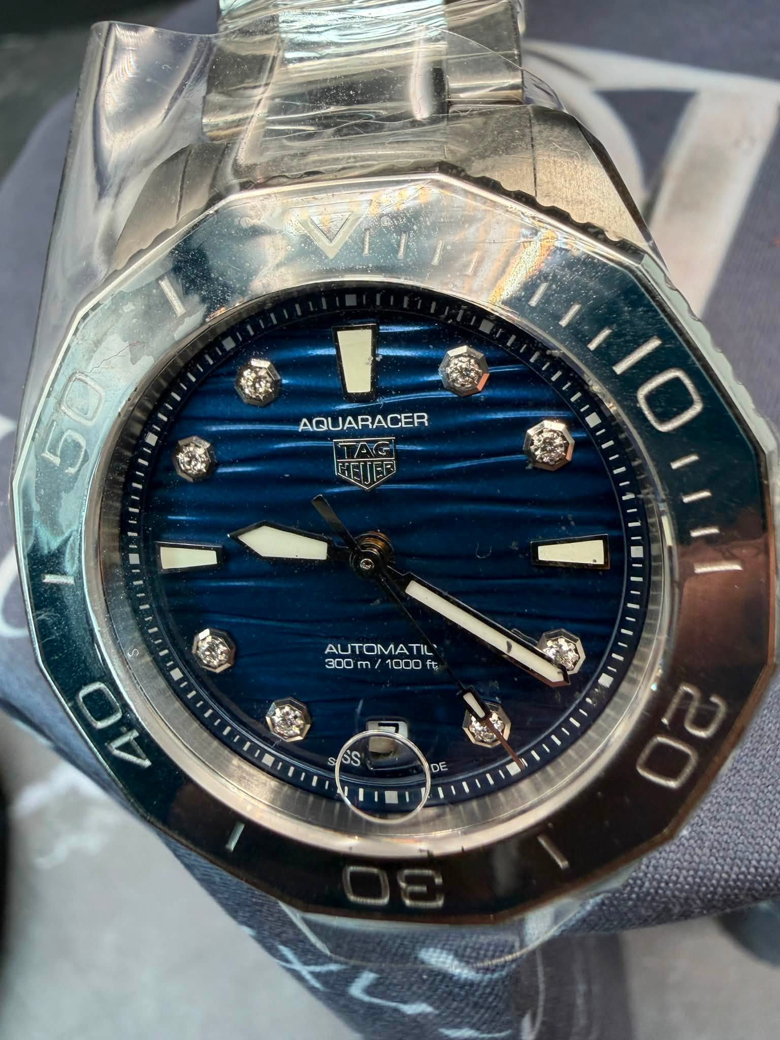 May be an image of wrist watch and text that says 'AQUARACER AUTOMATIL' 300 300m 1000 300m/1000f ft 5 開 O 1V 4 安 SS AIC DE'