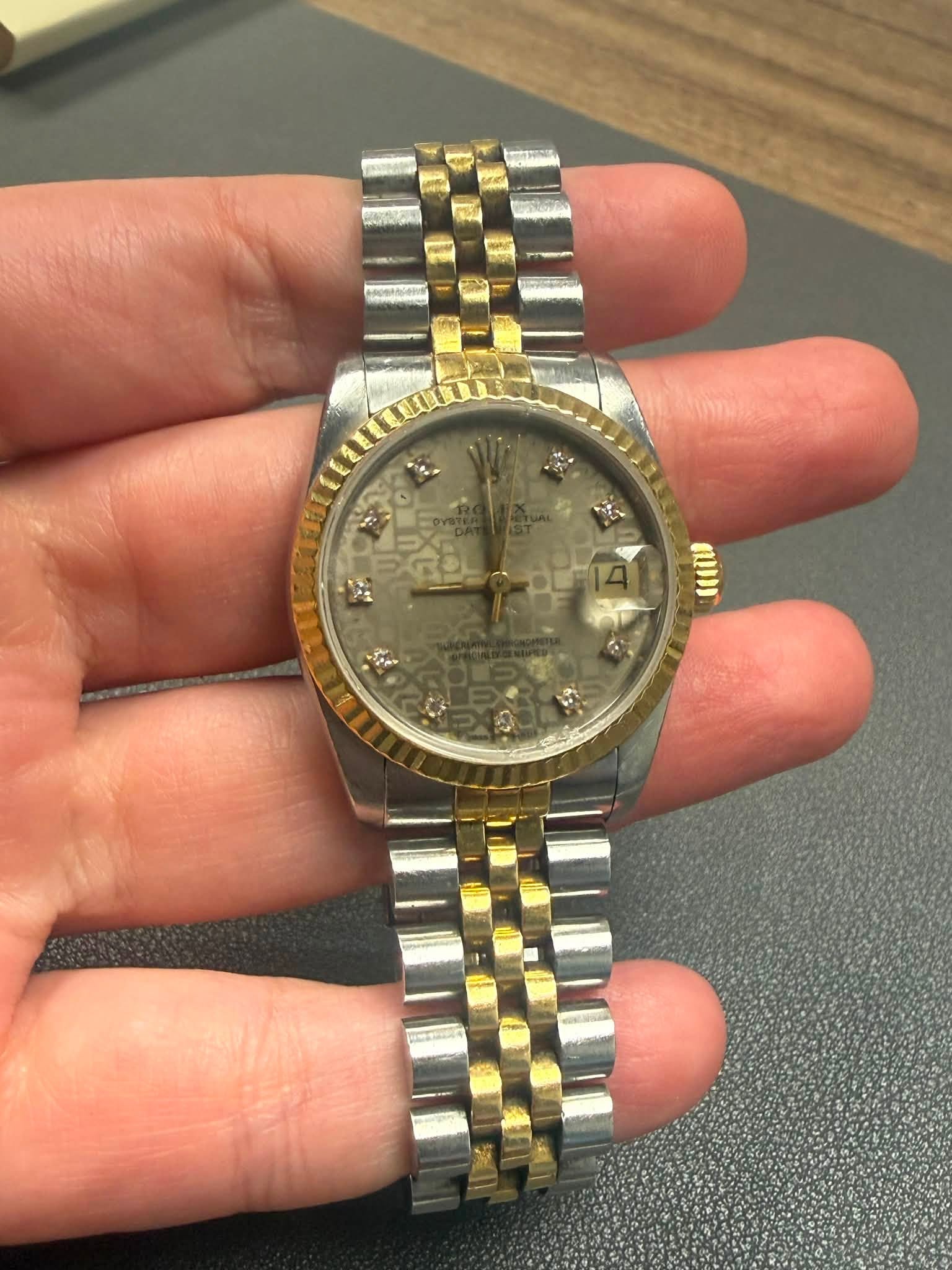 May be an image of wrist watch and text