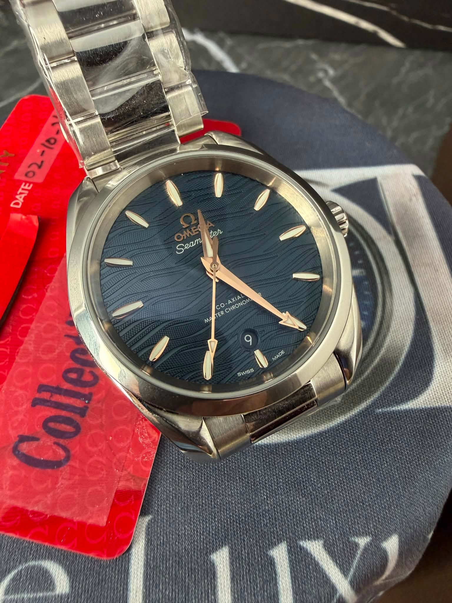 May be an image of wrist watch and text that says '02-10-> DATE tor Seam 9 ART ARM CO 26 TER CHROMO AX ΧΙΑ A MACE SwAS Collen'