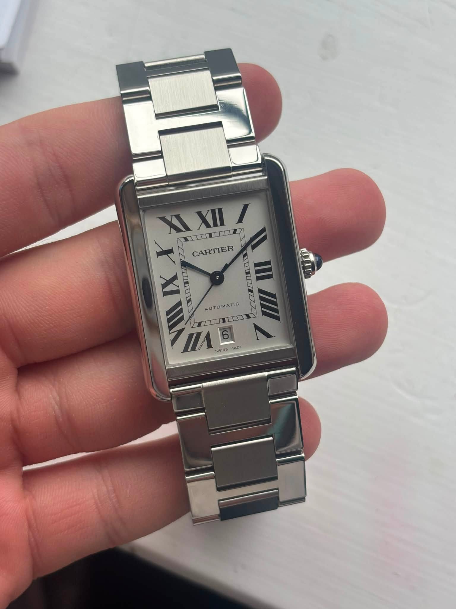 May be an image of wrist watch and text
