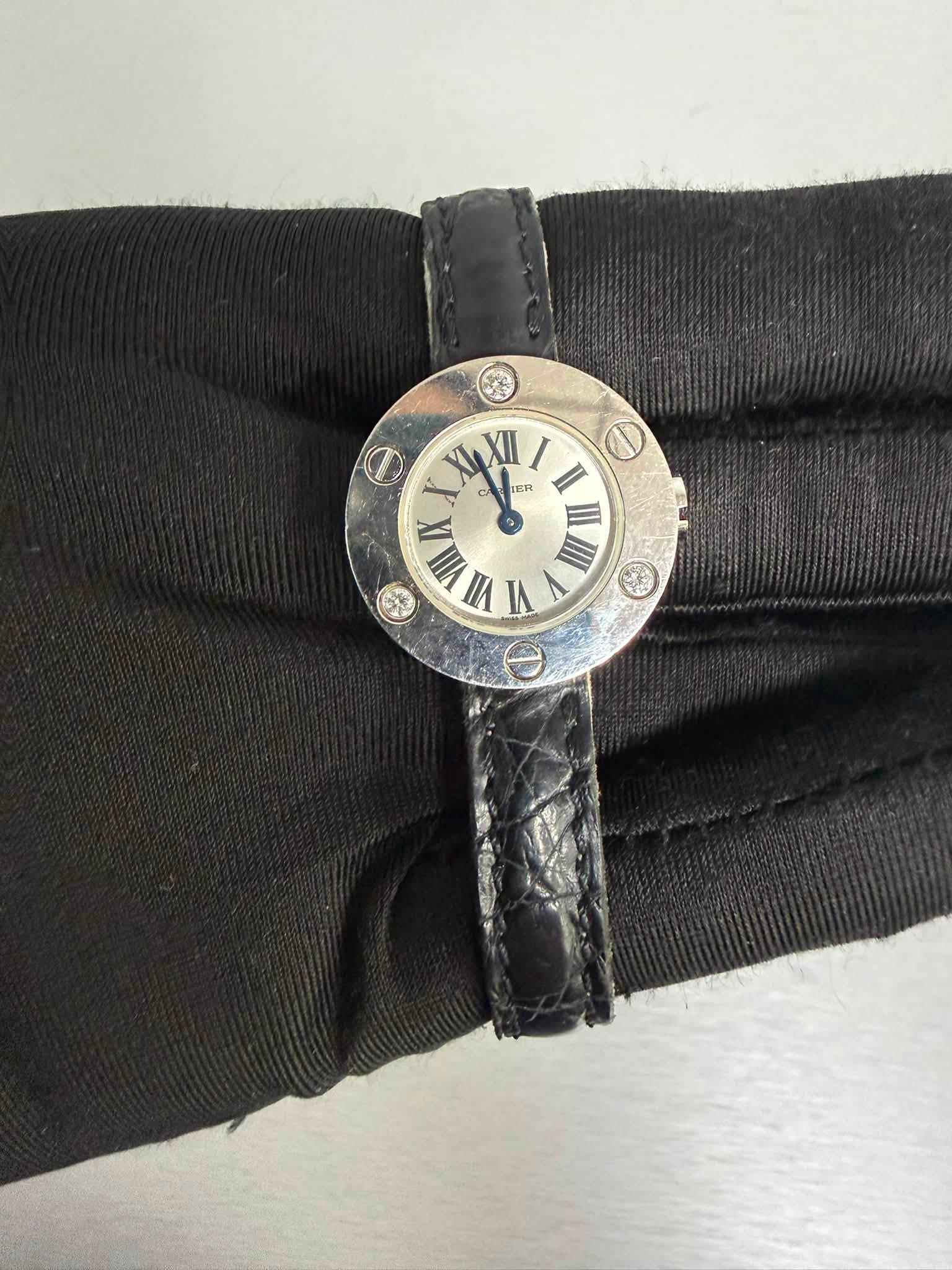 May be an image of leather, wrist watch and text that says 'XyXI X4 XII KER I 1 II VIIA VI III Θ'
