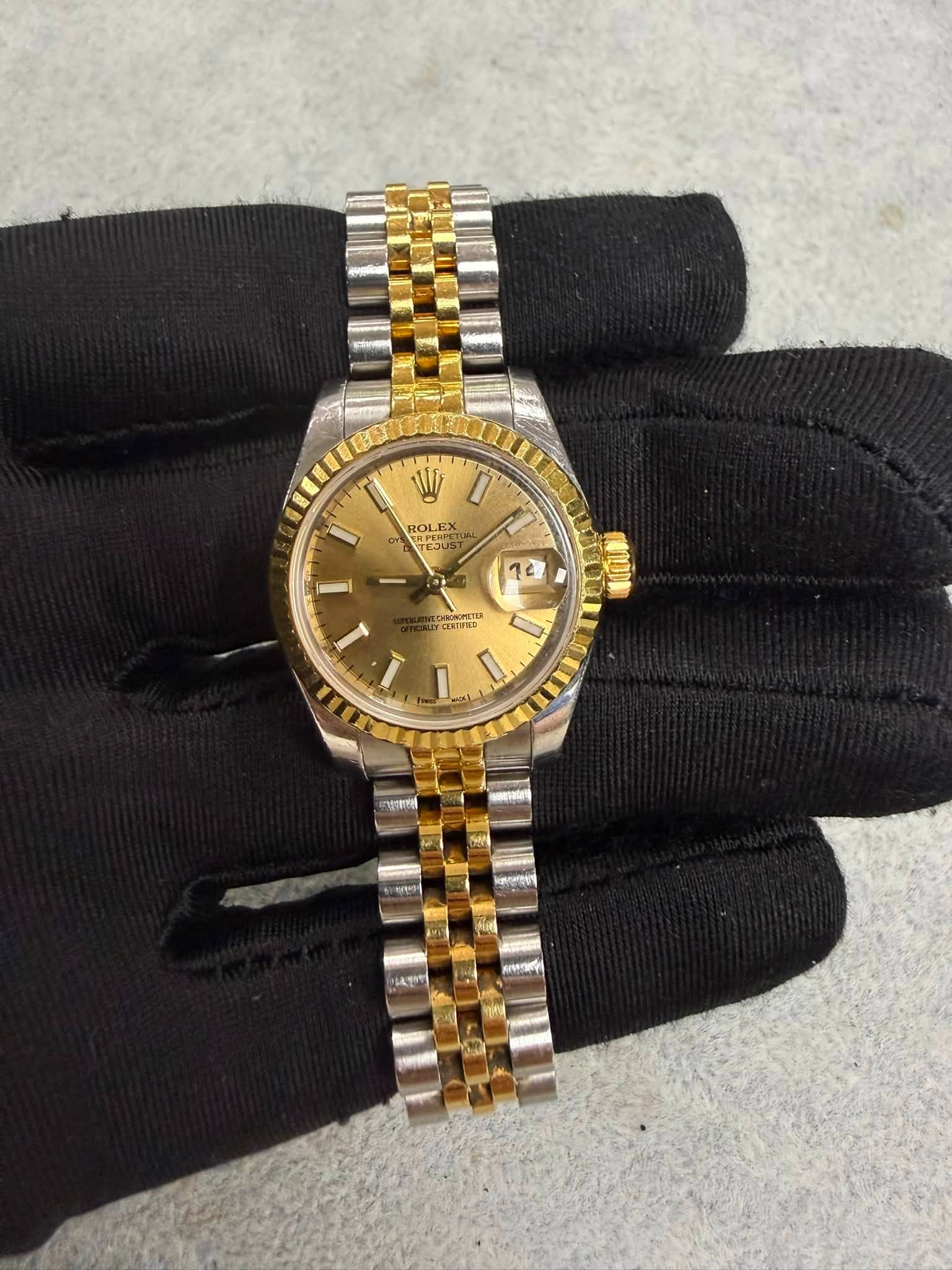 May be an image of wrist watch and text
