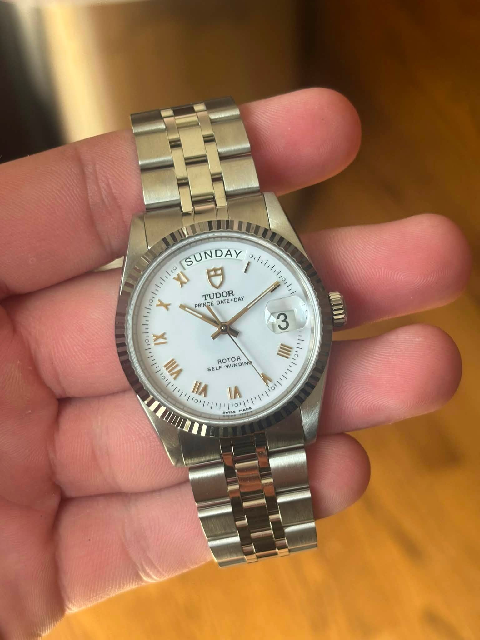 May be an image of wrist watch and text