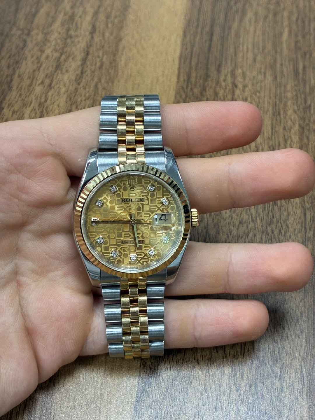 May be an image of wrist watch and text