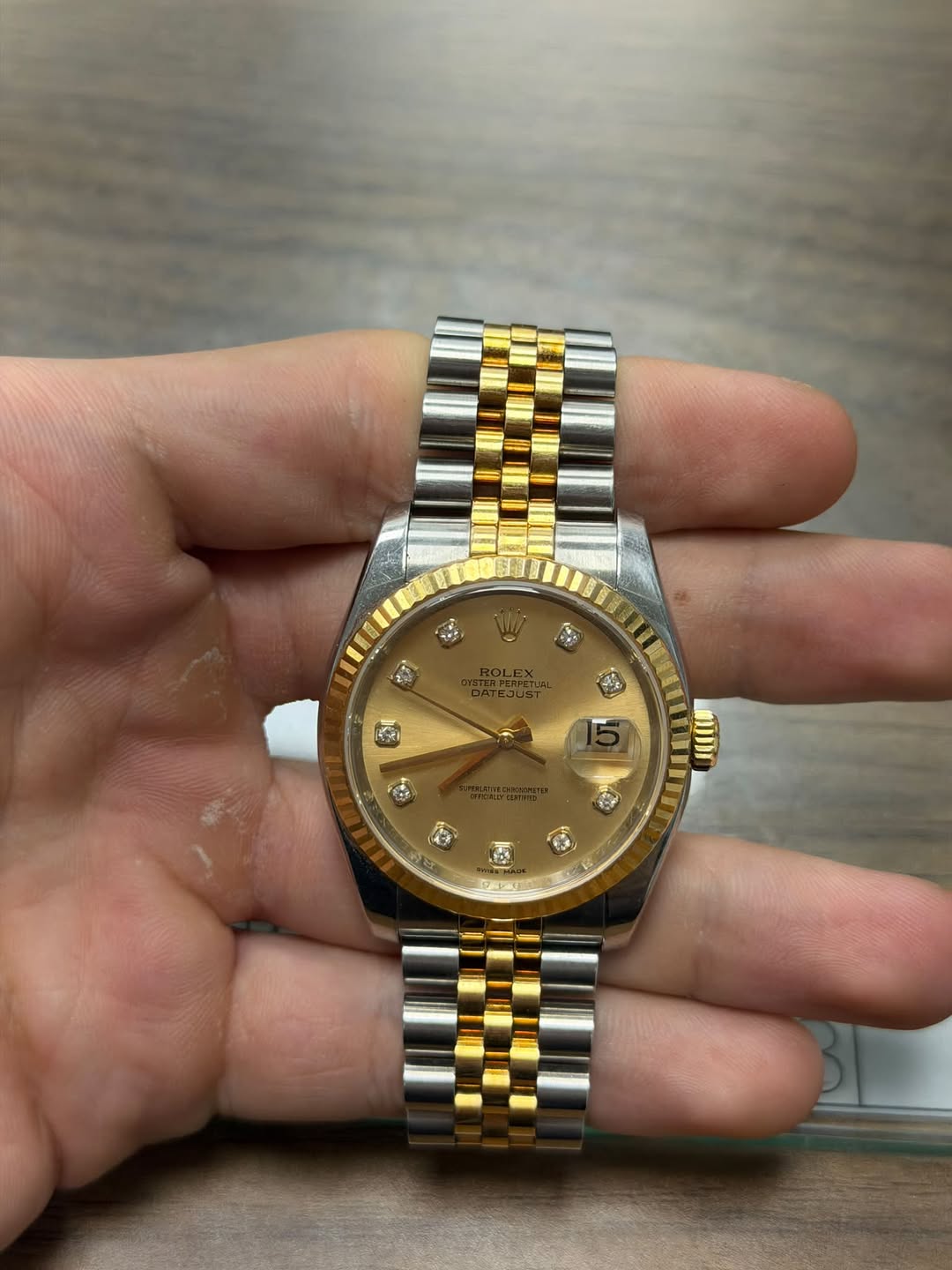 May be an image of wrist watch and text