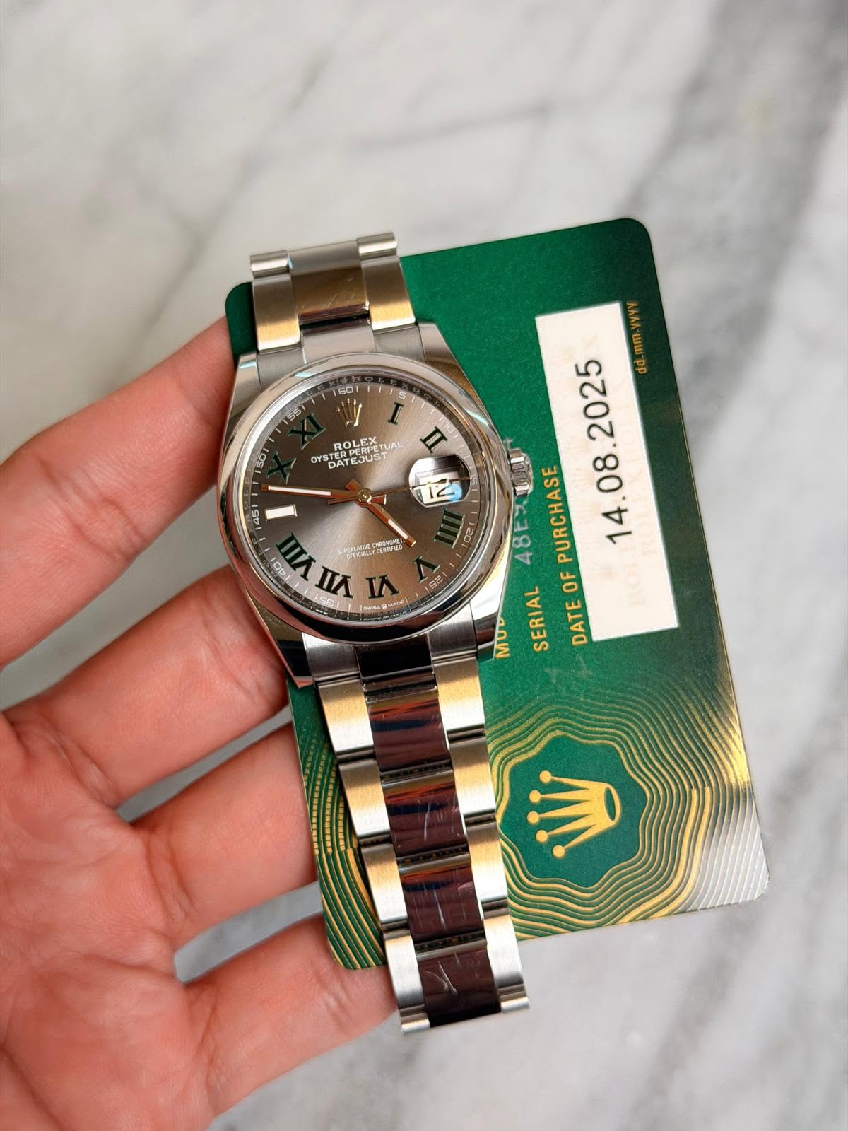 May be an image of wrist watch and text
