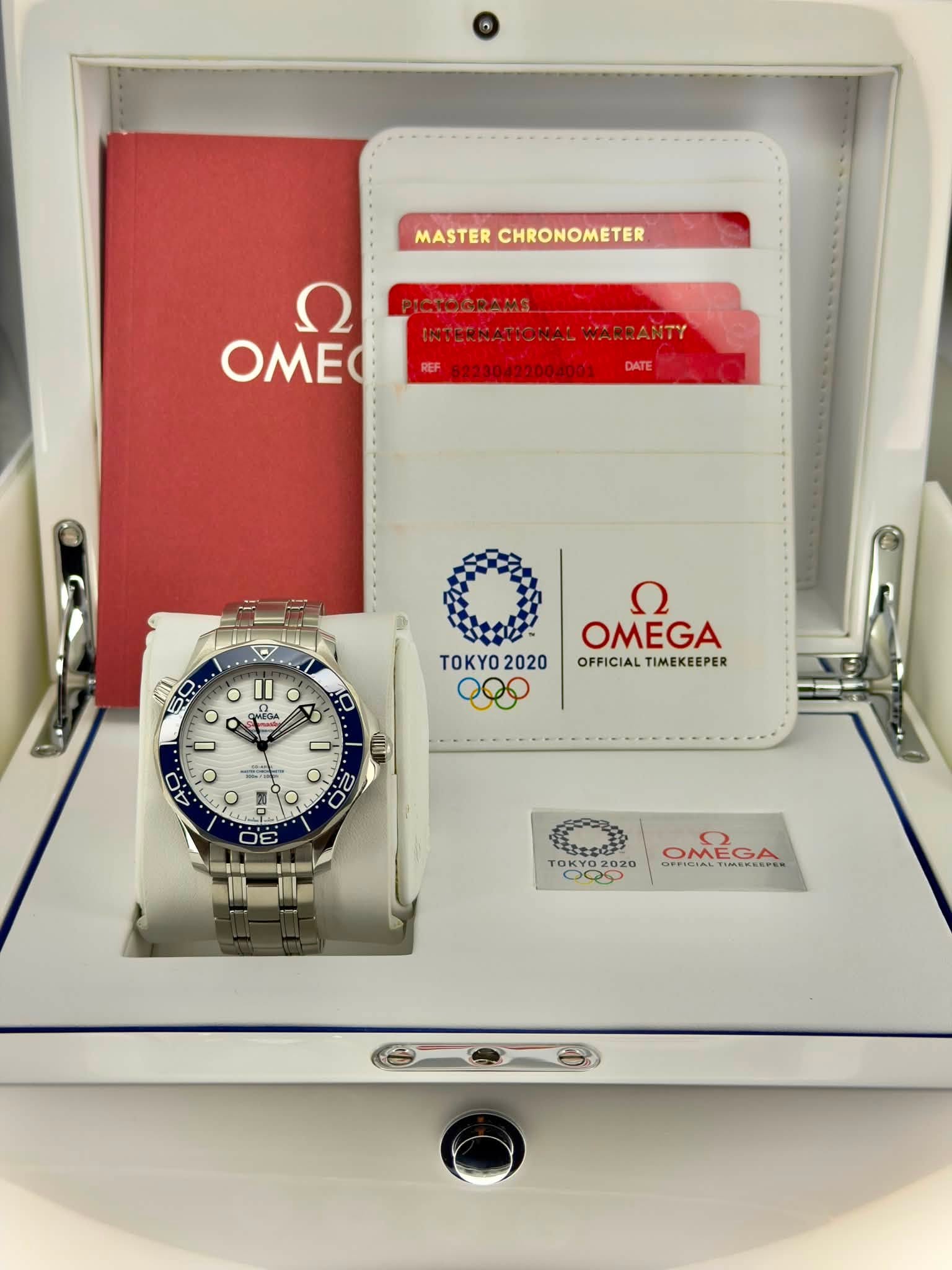 May be an image of wrist watch and text that says 'MASTER ASTERCHRONOMETER CHRONOMETER Ω OMEO PICTOGRAMS INTERNATIONALW WARRANTY DATE O II CAEGAA o ספפצאר TOKYO 2020 - OMEGA…