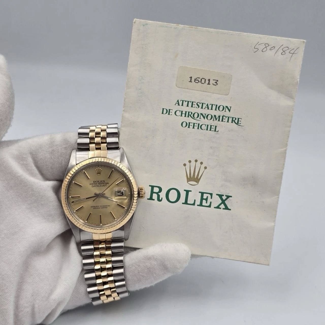 May be an image of wrist watch and text that says '580/84 16013 DE ATTESTATION CHRONOMETRE DECHRONOMETRE OFFICIEL oepcT ROLEX'