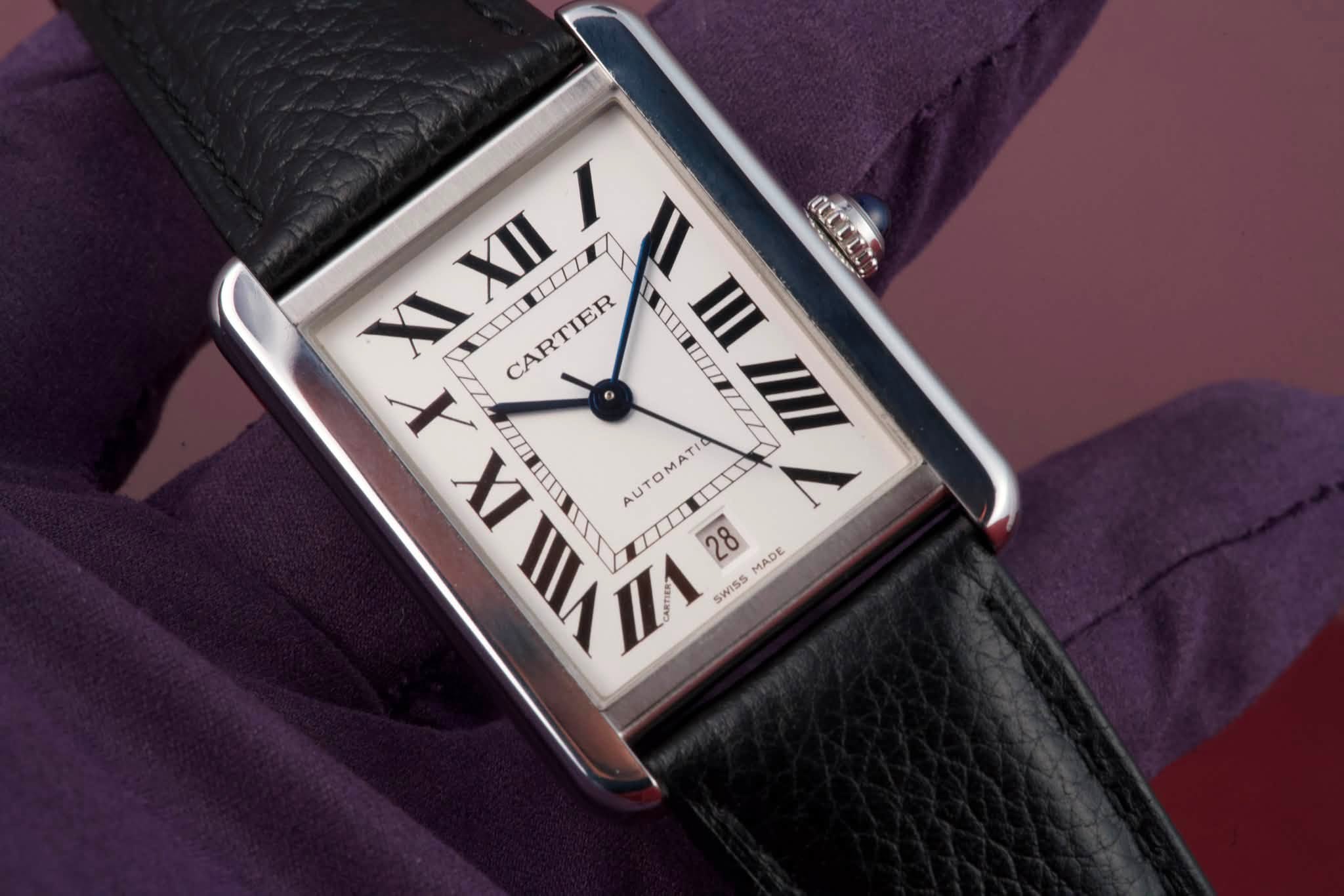 May be an image of wrist watch and text that says 'CtTC XII XIXIII I I II XI CARTIER HIII II III X IX AUTOMATI T VII F 28 28 MADE SWISS'