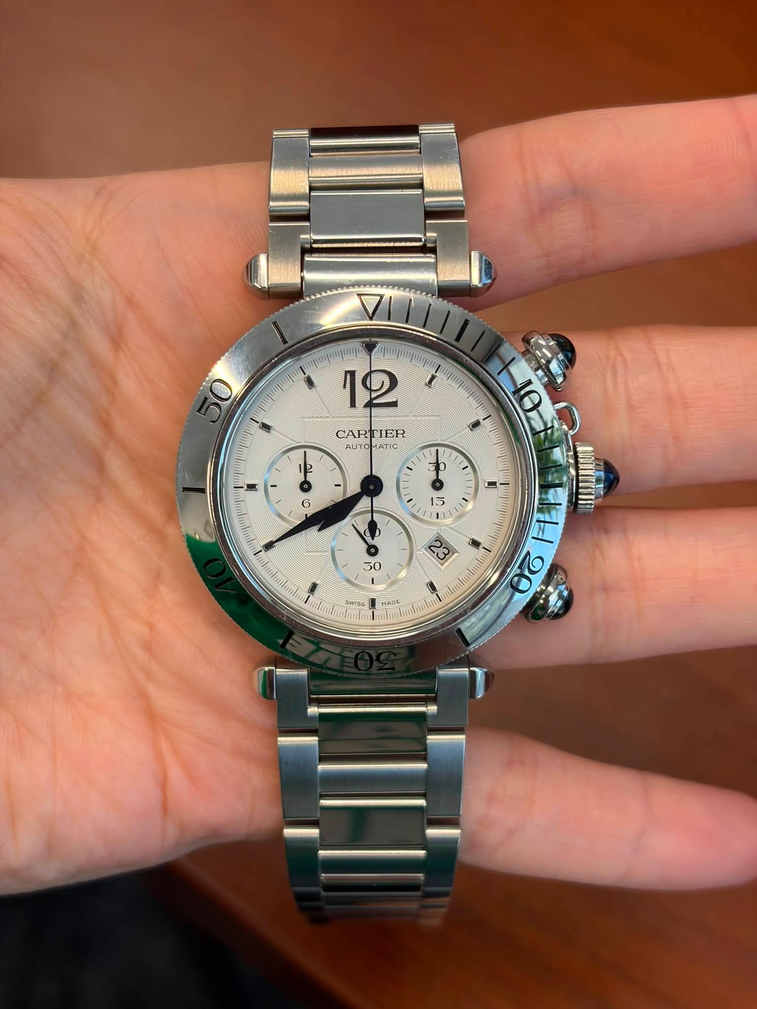 May be an image of wrist watch and text