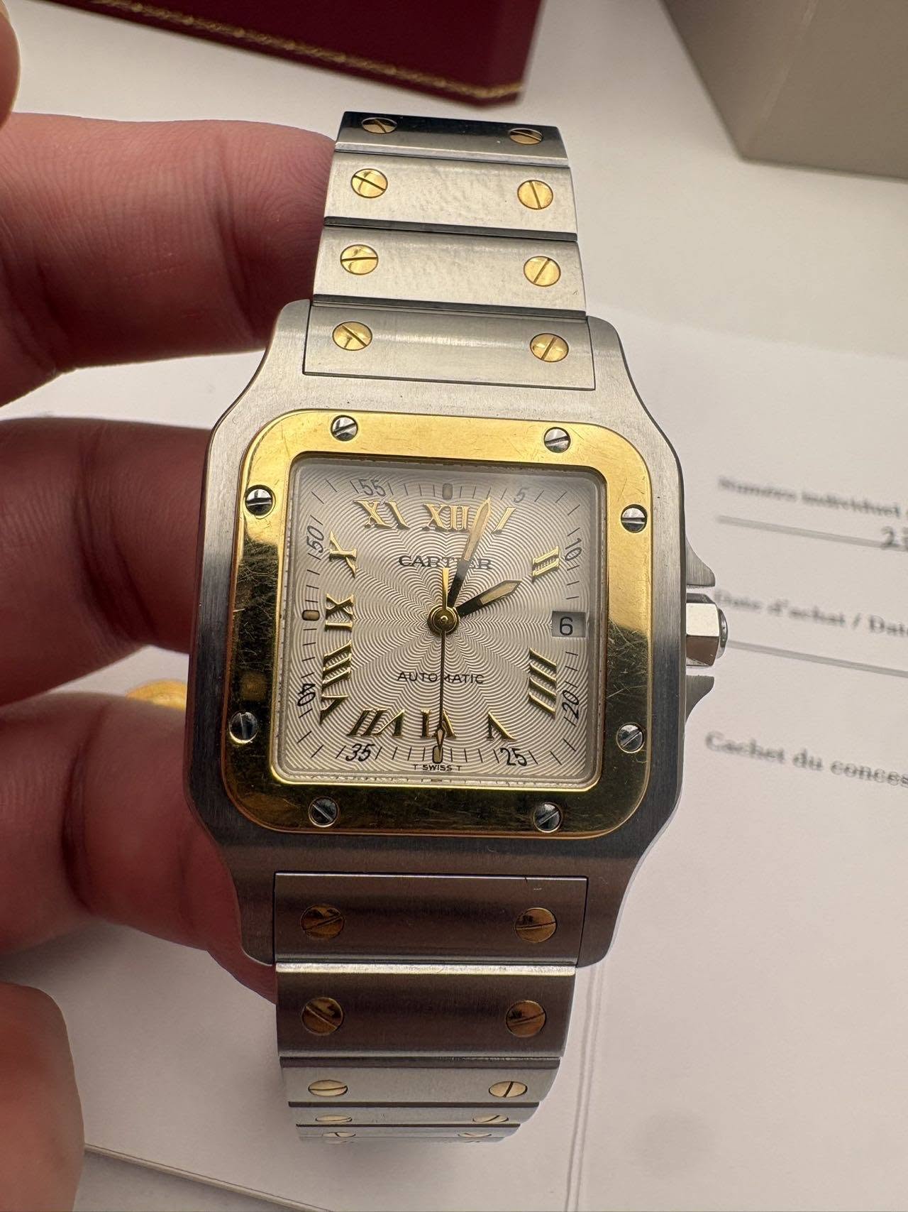 May be an image of wrist watch and text