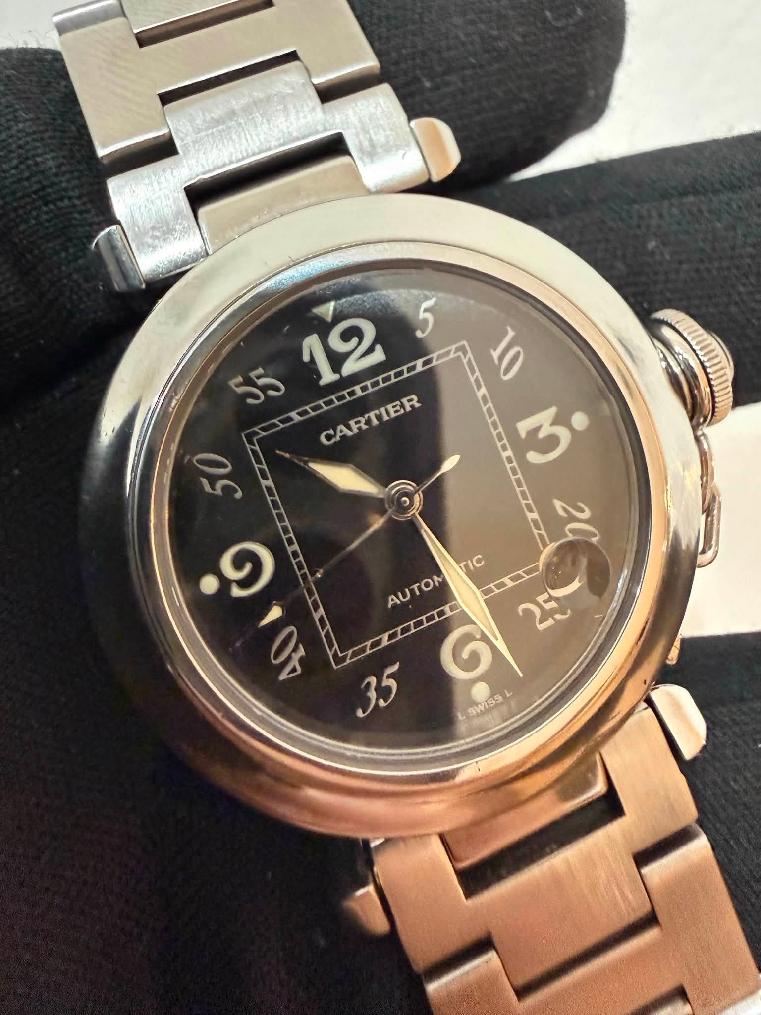 May be an image of wrist watch and text that says '5 55 12 微微微 CARTIER . 10 CARTIER 50 ب ១ TIC 9 2 AUTOM TOM AU II m G SWISS'
