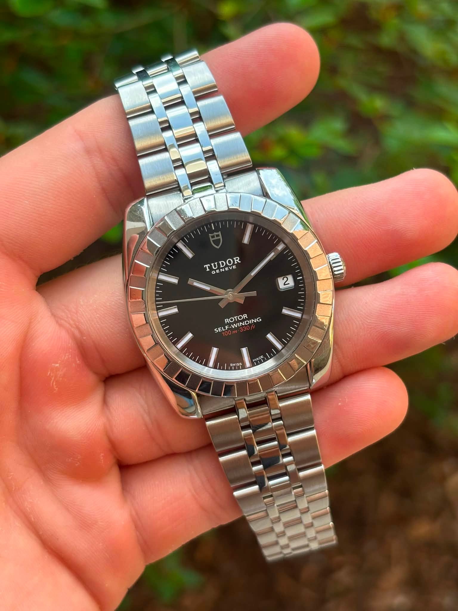 May be an image of wrist watch and text that says 'TUDOR EV OF NE 2 ROTOR WINDING DING SELF I ADE 正質'
