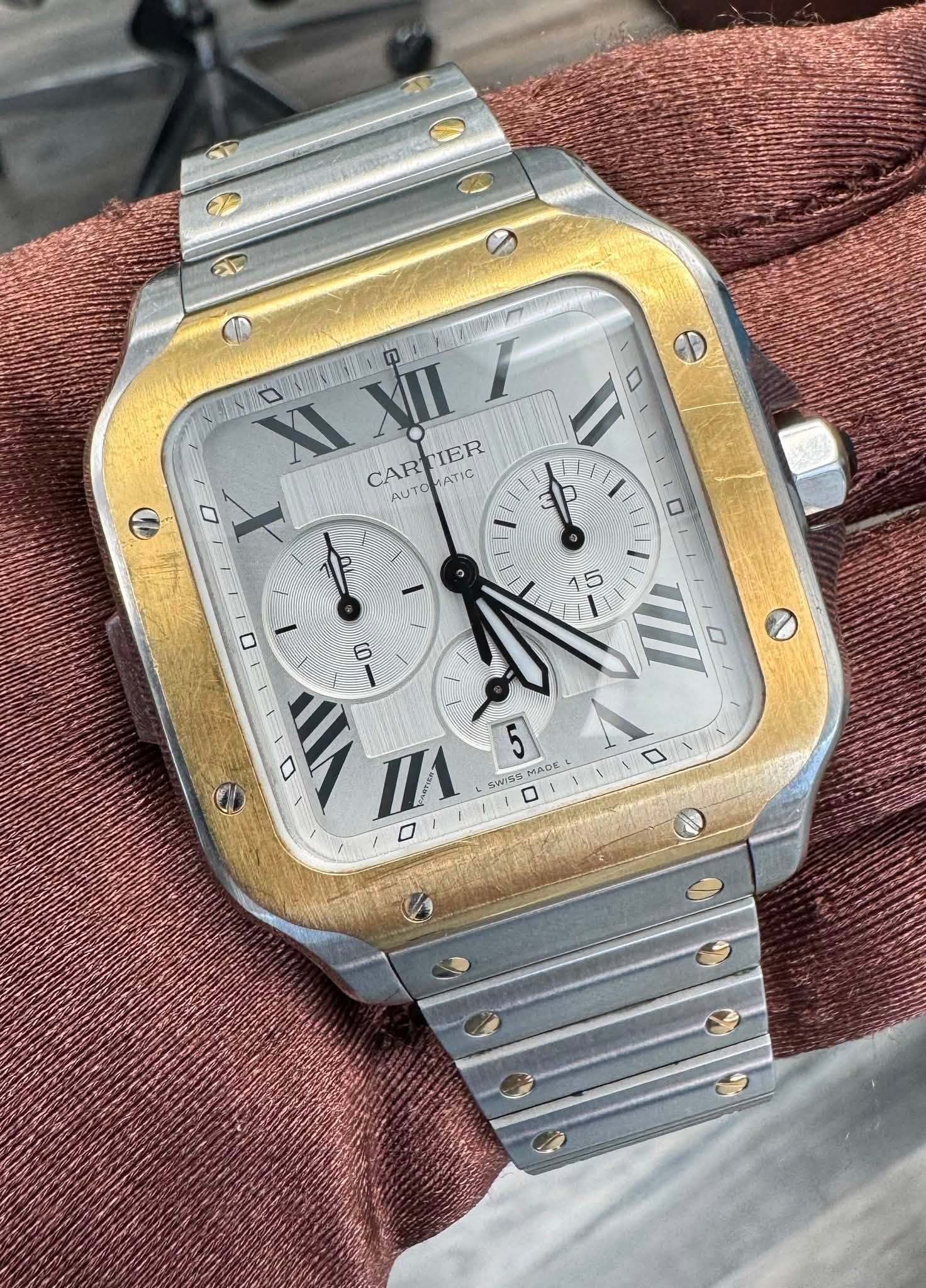 May be an image of wrist watch and text that says 'aD 0 HS口 XI 0 VII CARTIER UTORATIC ATIC CAR IER AUTO 0 1 0 1P 15 6 ١ VII 0 ٥ 5 SWISS MADE OE WISSMADE'