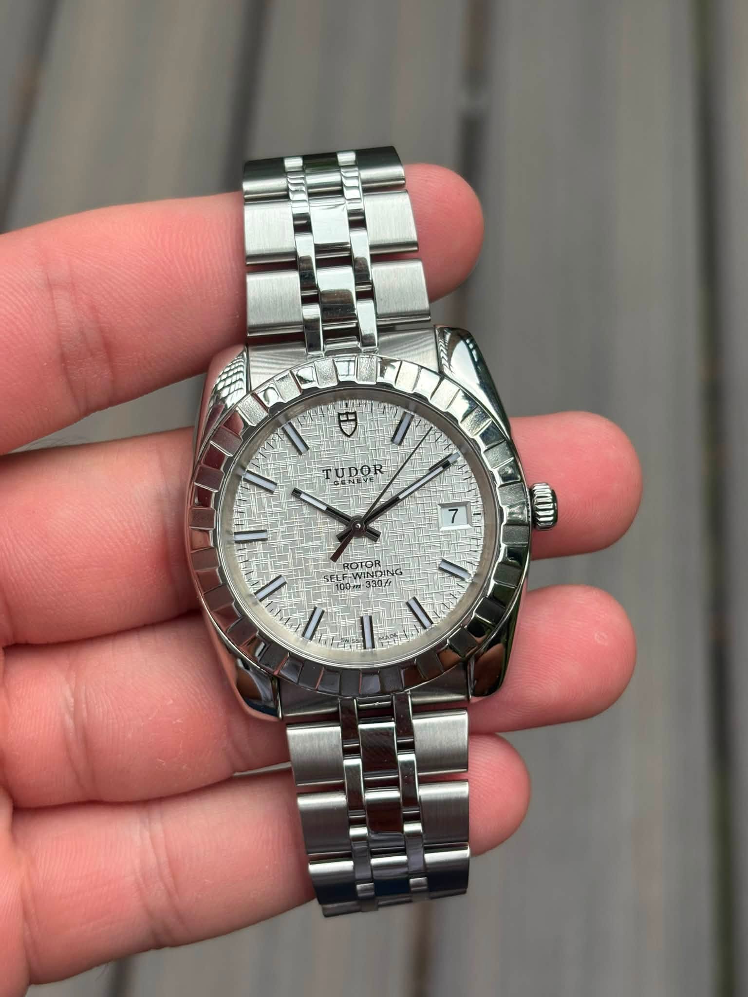 May be an image of wrist watch and text
