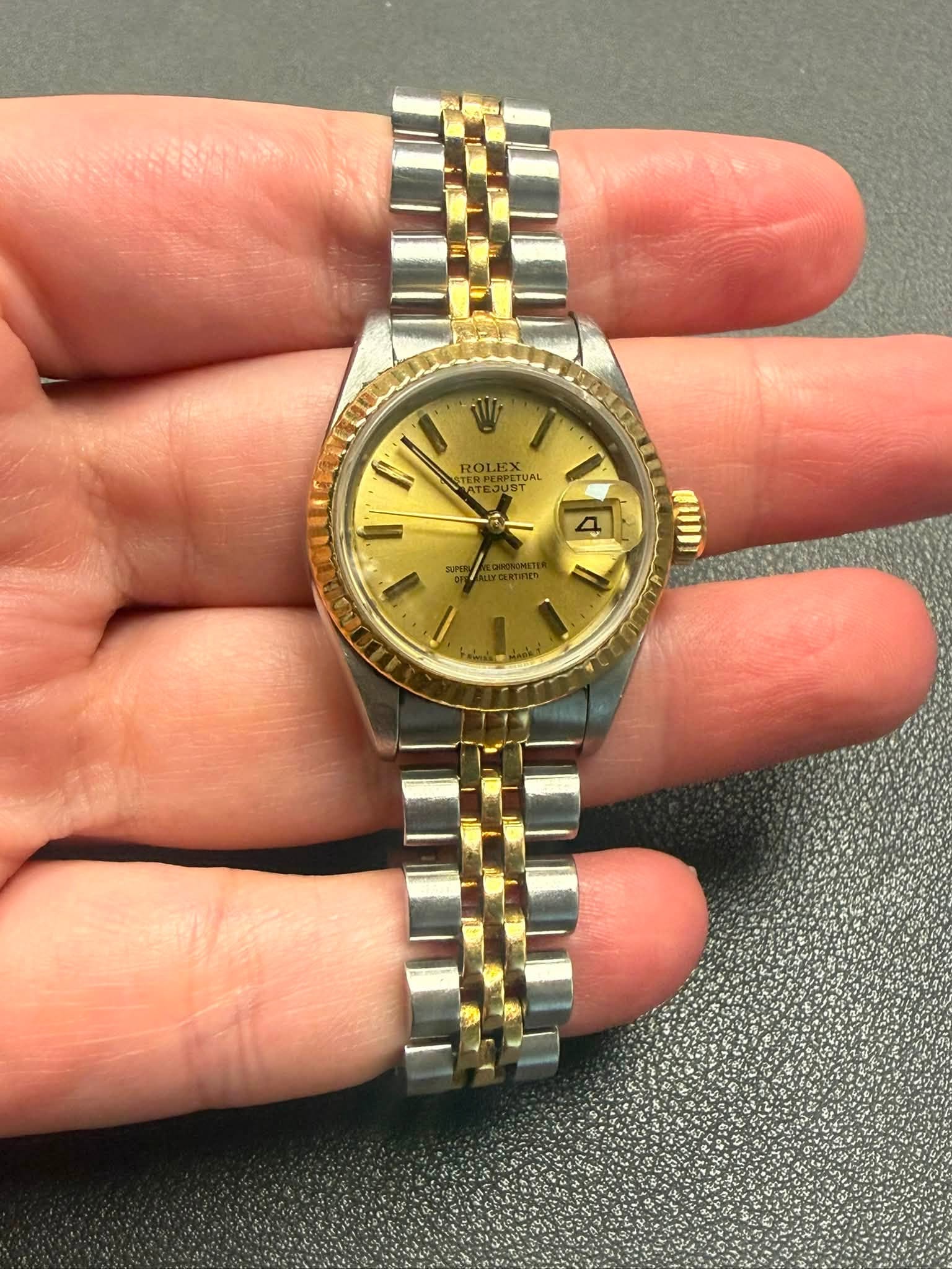 May be an image of wrist watch and text