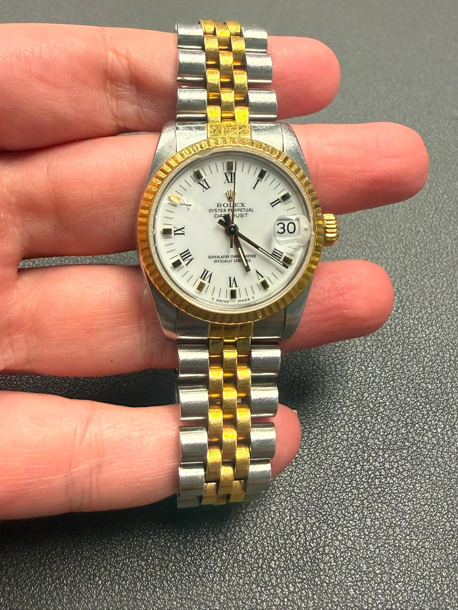 May be an image of wrist watch and text