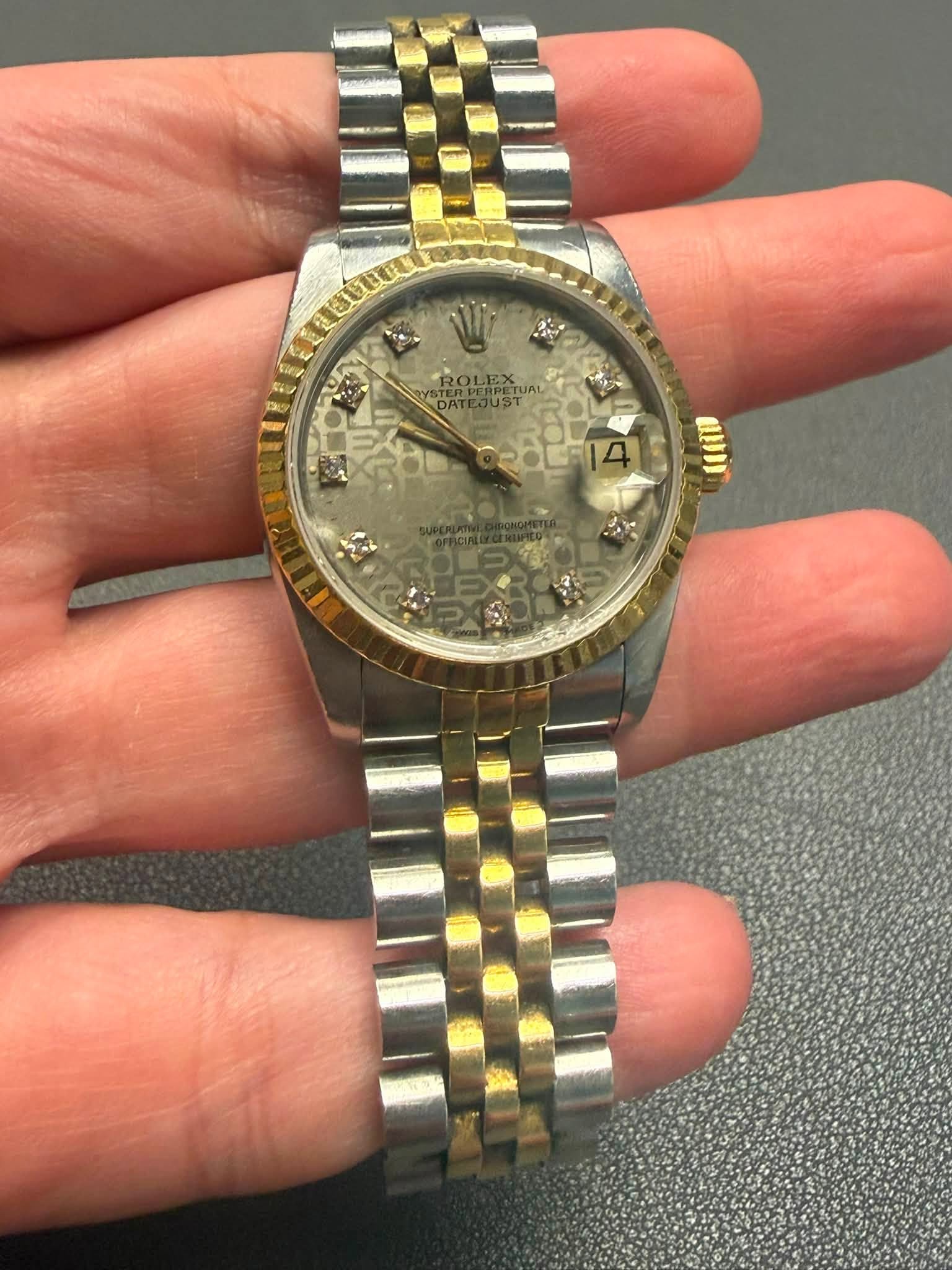 May be an image of wrist watch and text