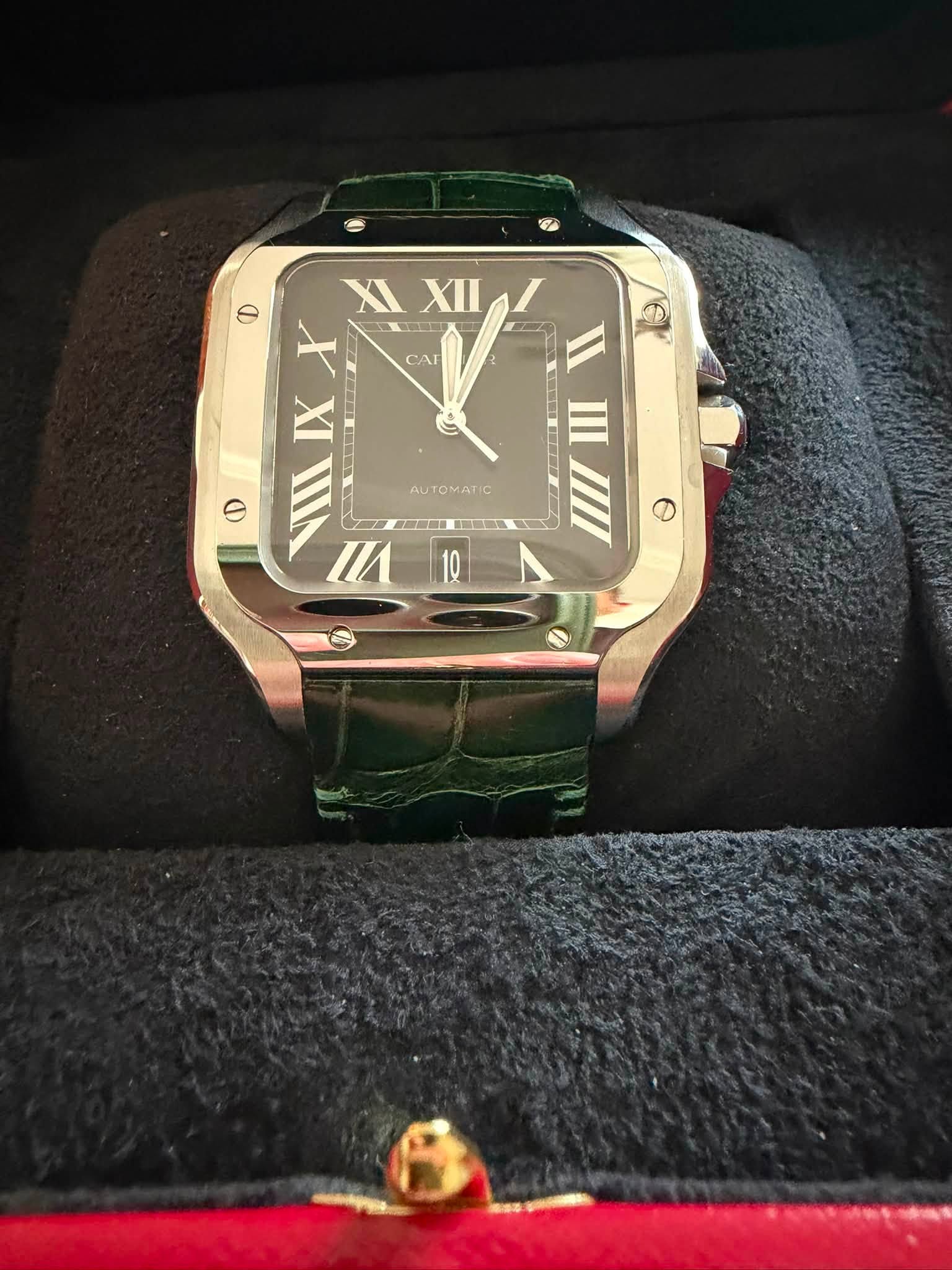 May be an image of wrist watch and text that says 'CAI D IXX XI XII XII X IX NII EII CIIIELD I O VIII N И Ⅲ RET T AUTOMATIC Θ'