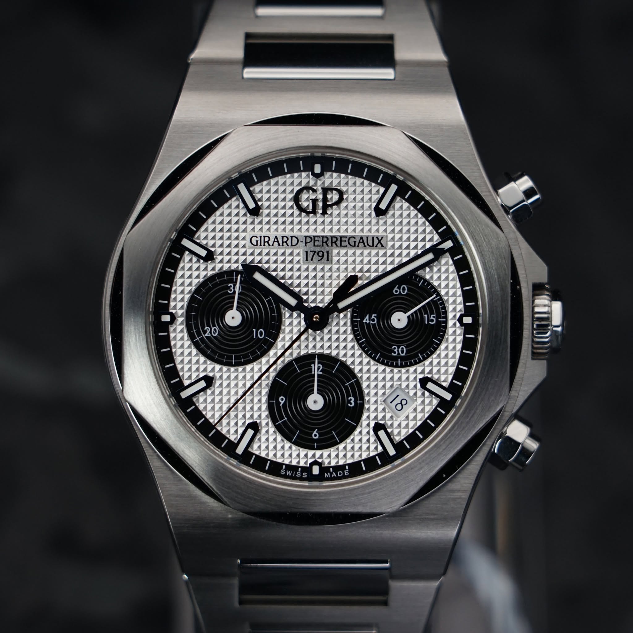 May be an image of wrist watch and text that says 'GIRARD- πππήη ع 0 8 6 AF MADE'