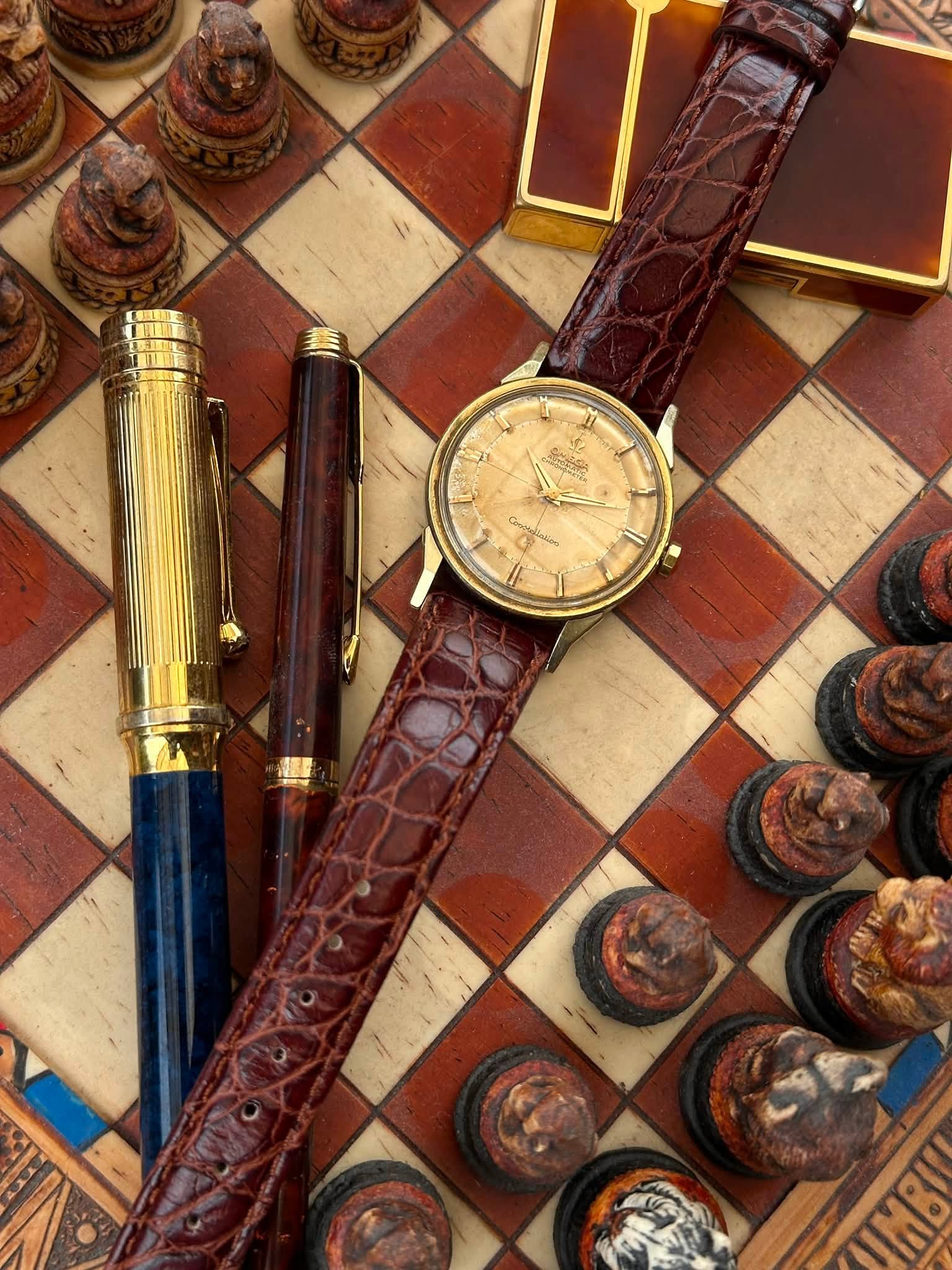 May be an image of wrist watch, chess and text