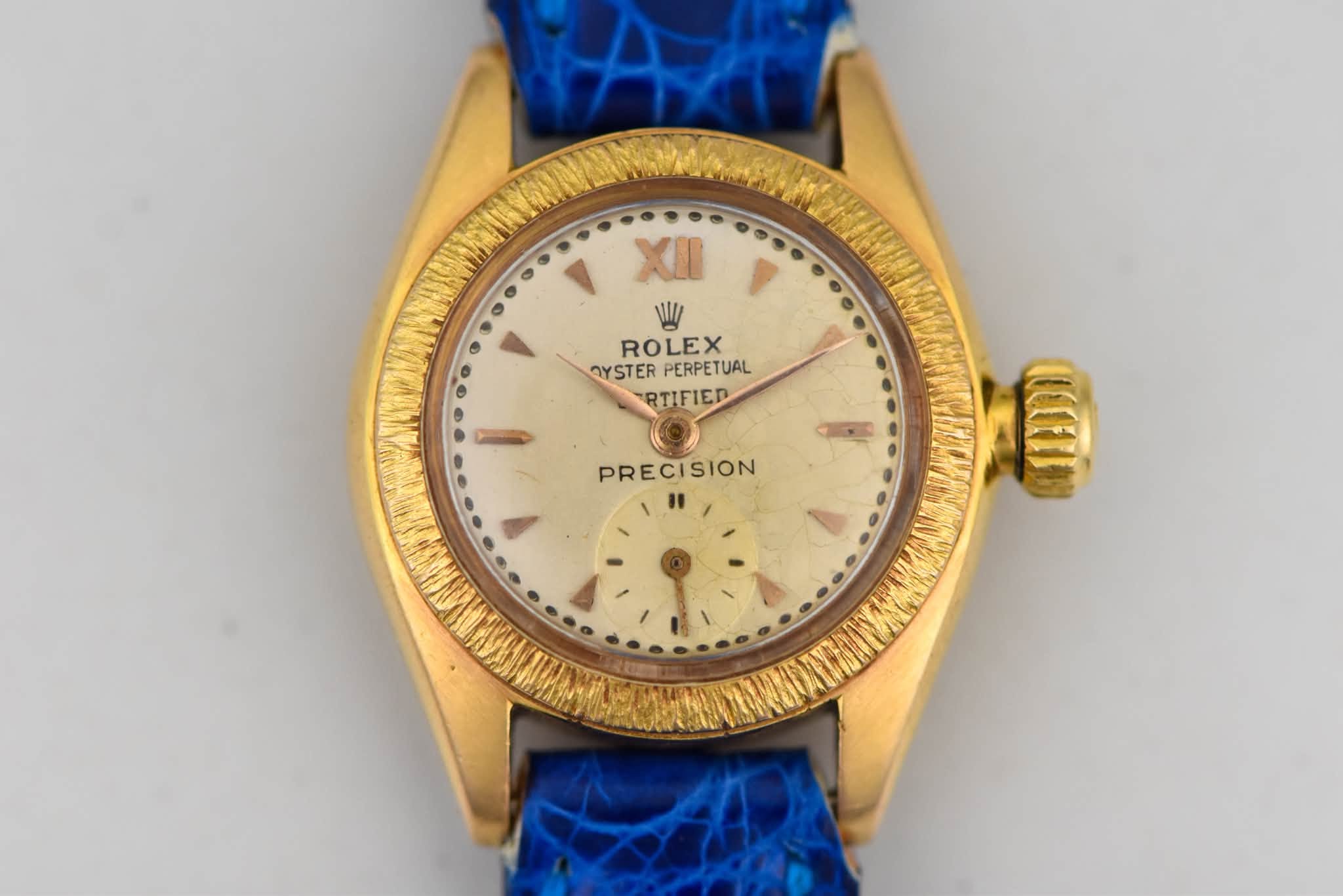 May be an image of wrist watch and text that says 'XII NWI ROLEX OYSTER OYSTERPERPETUAL PERPETUAL RTIFIED PRECISION'