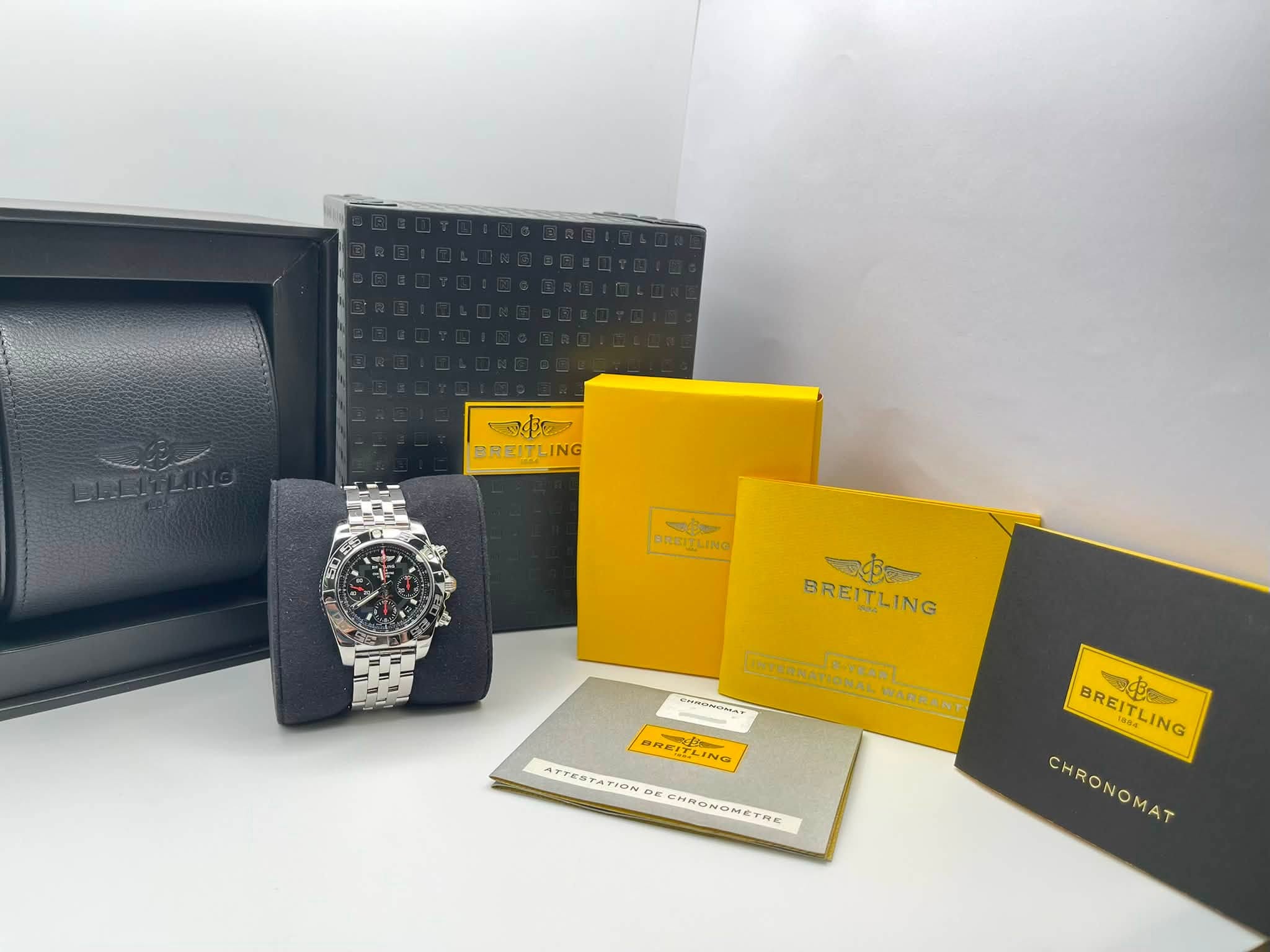 May be an image of wrist watch, leather and text