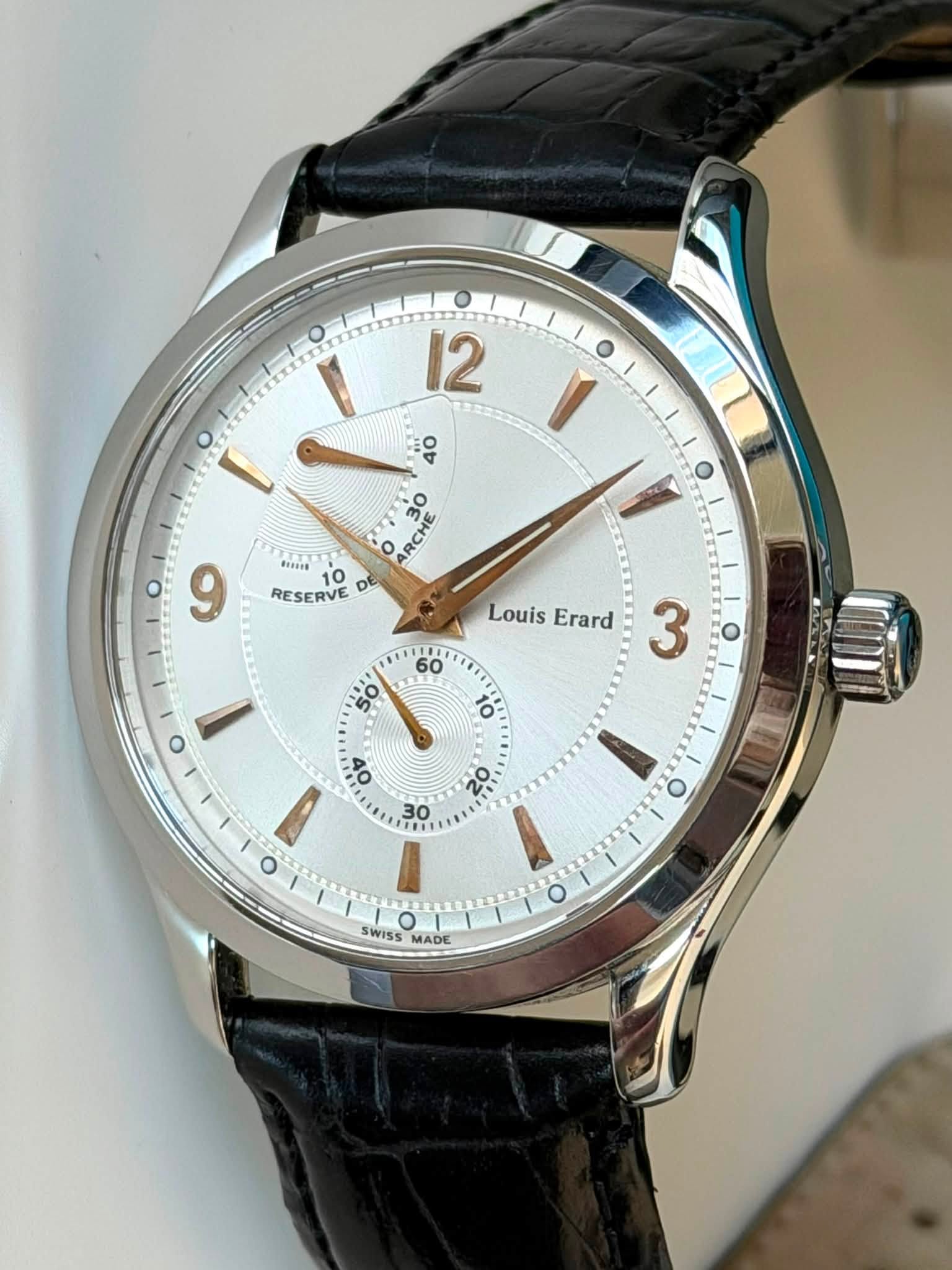 May be an image of wrist watch and text that says '12 40 ARCHE 30 9 RESERVE DE Bonis 10 Louis Erard 60 O 50 3 O 10 % 心 30 O O O O WiS MADE ADE D EL'