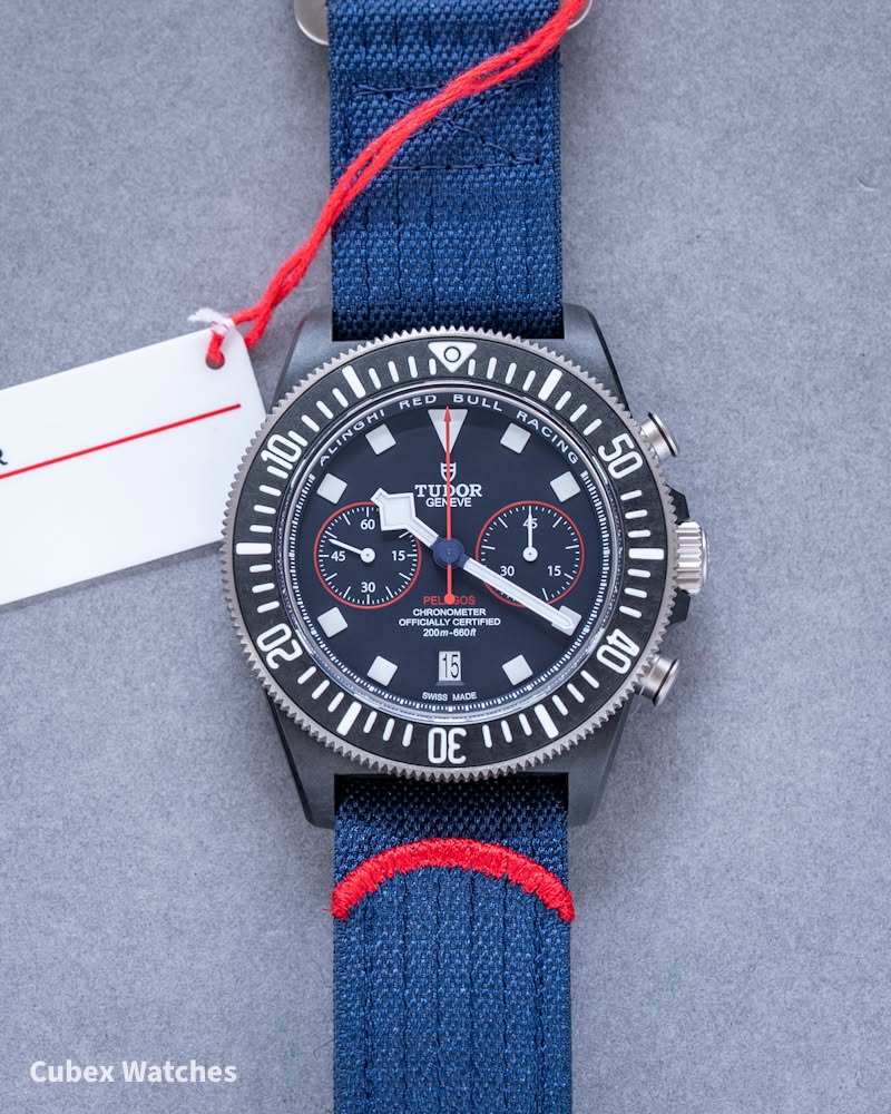 May be an image of wrist watch and text that says "RED O O MI 10 Usl BULL RA CING N 50 日 TUDOR OR NOMETER PRICATLYCE CHRONOMETER CERT ED 200m- 200m-680f 20 15 SWISS MADE ਤ 40 30…