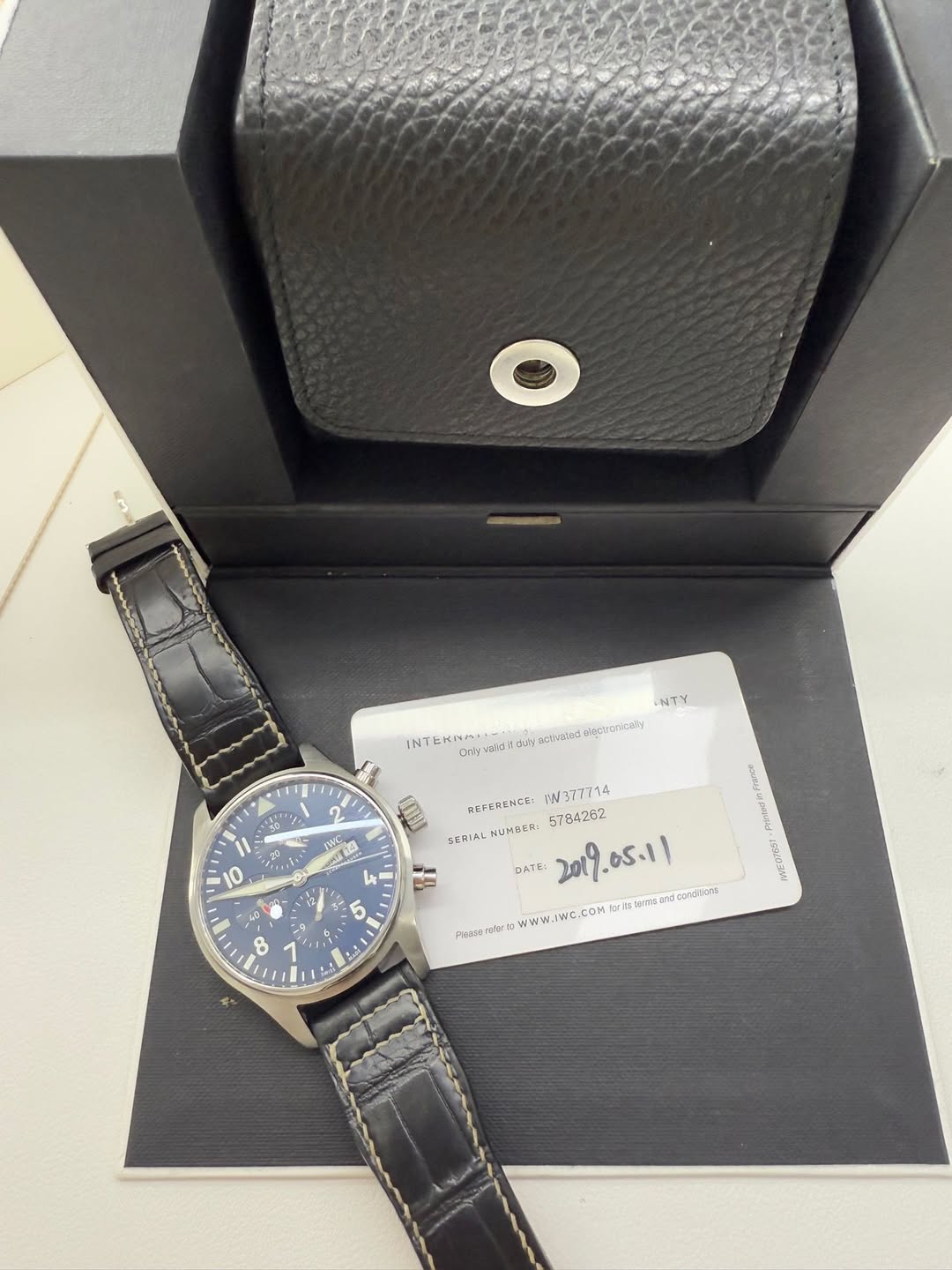 May be an image of leather, wrist watch and text
