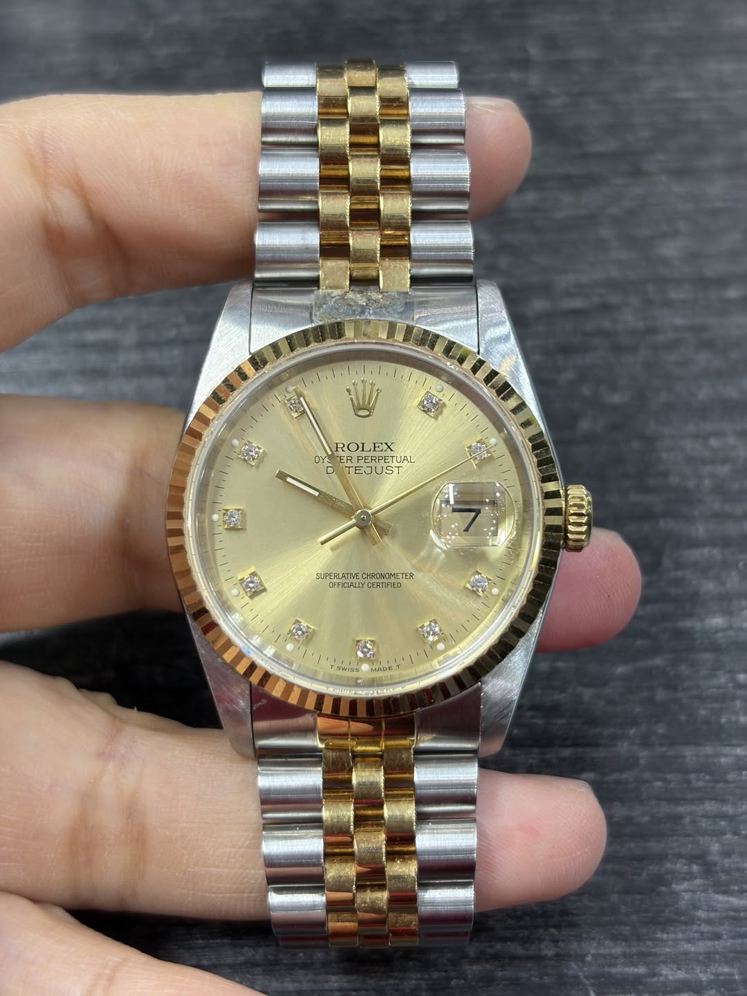 May be an image of wrist watch and text