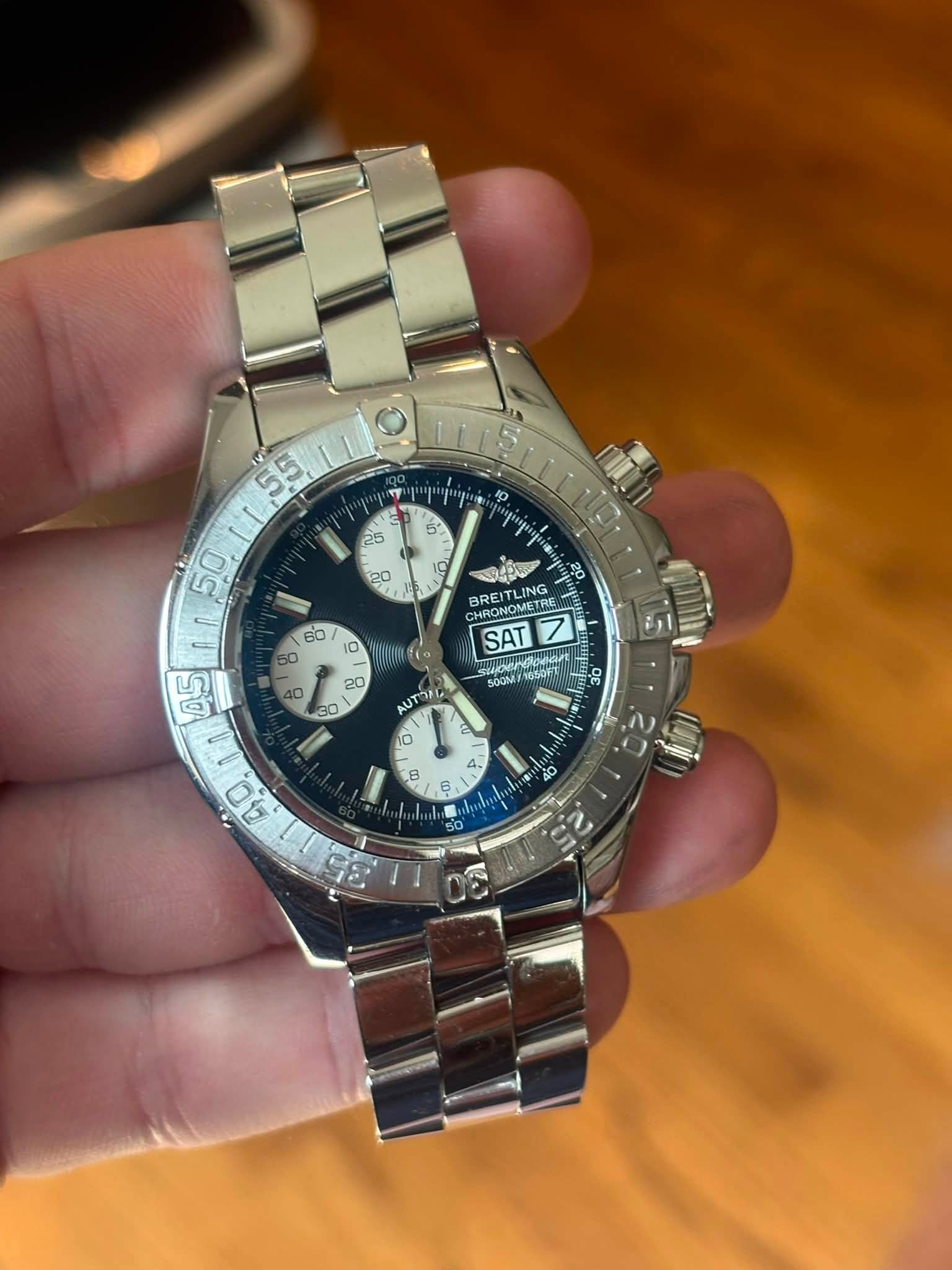 May be an image of wrist watch and text