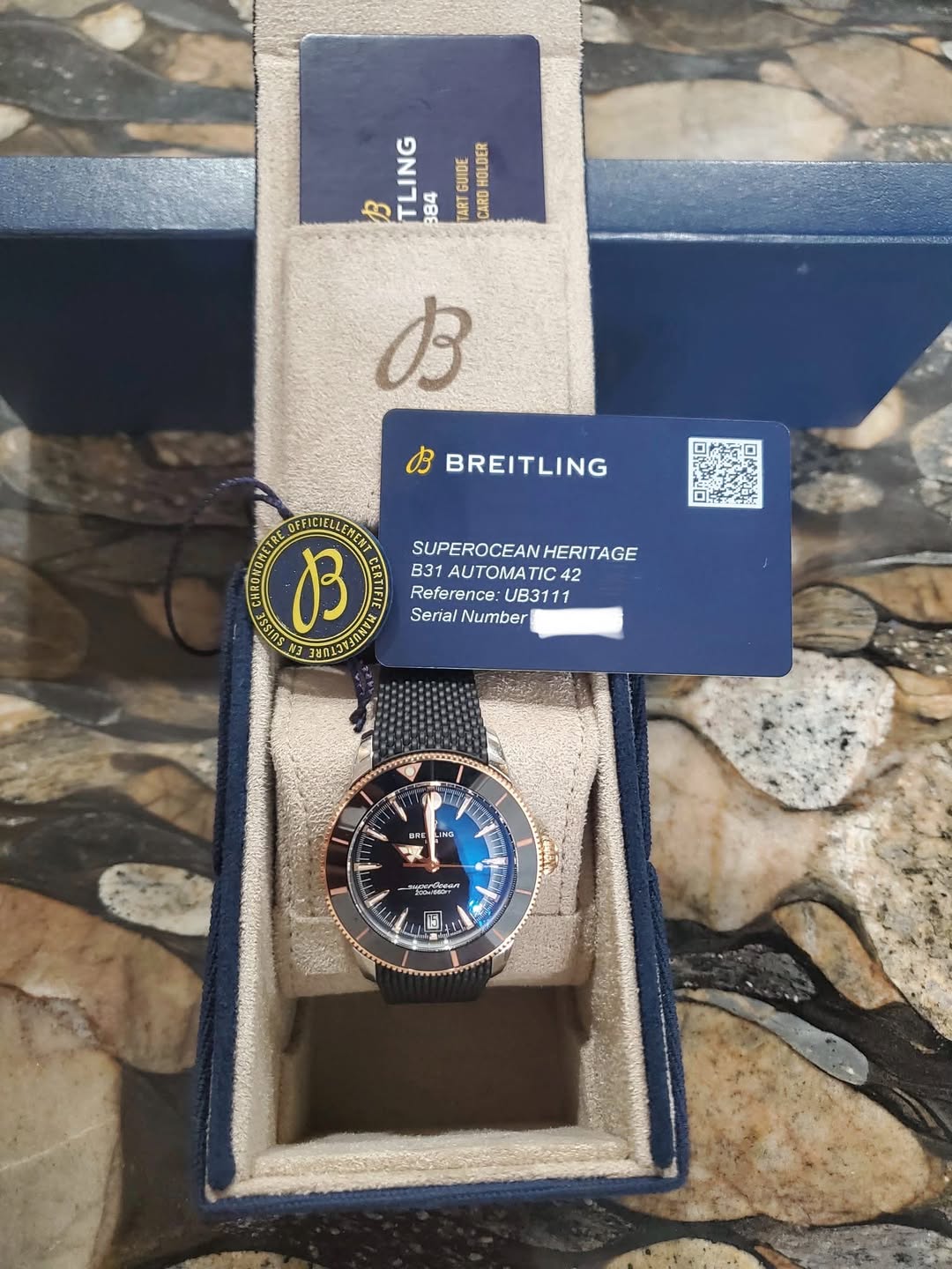 May be an image of digital watch and text that says 'GUIDE GUCE HOLDER B TLING 384 TART CARD B BREITLING B SUPEROCEANHERITAGE HERITAGE B31AUTOMATIC42 42 M ATIC42 Reference: UB3111…