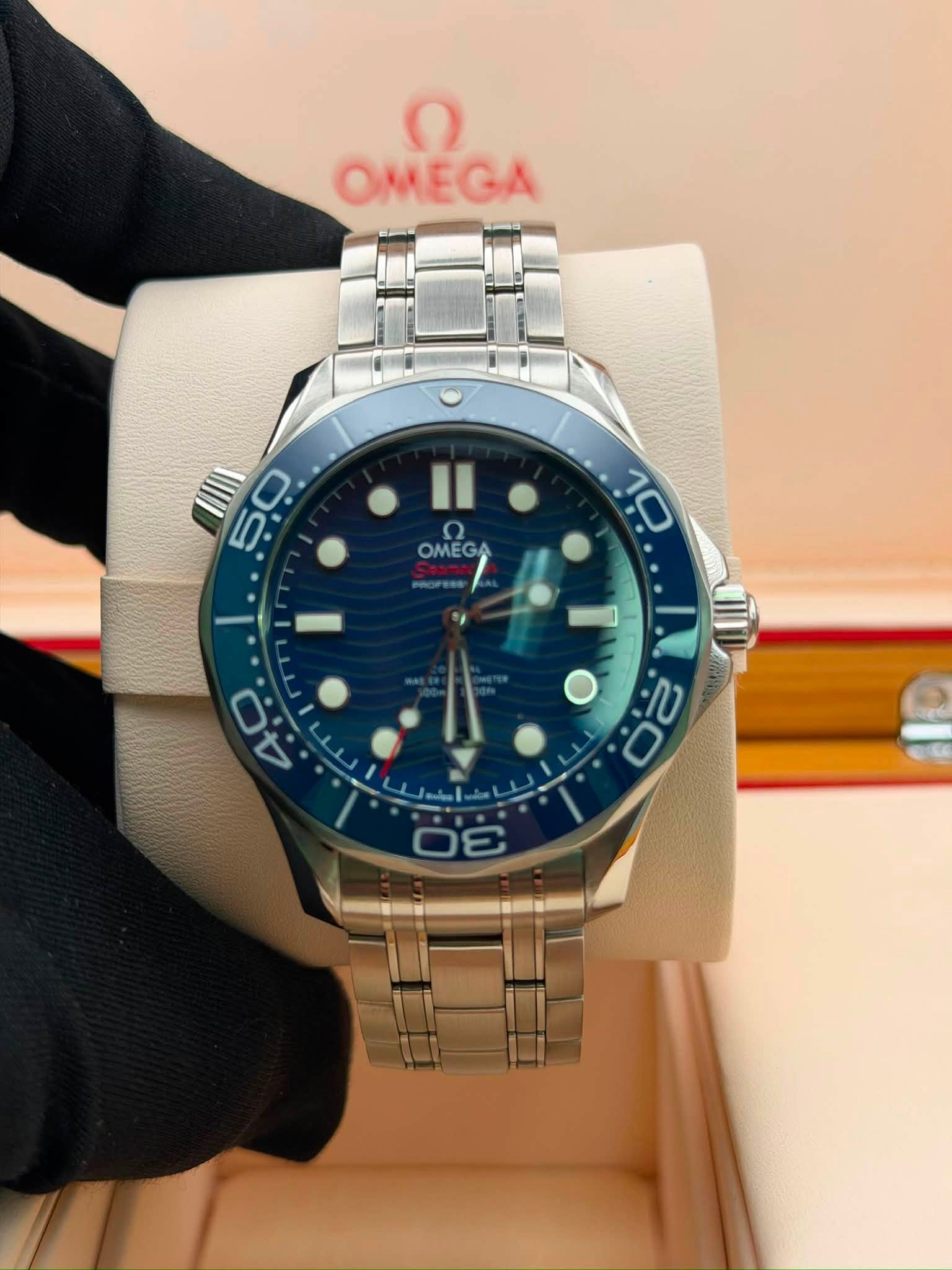May be an image of wrist watch and text that says 'OMeCa OMEGA 50 ب ဂ OMEGA OMEGA I.. '
