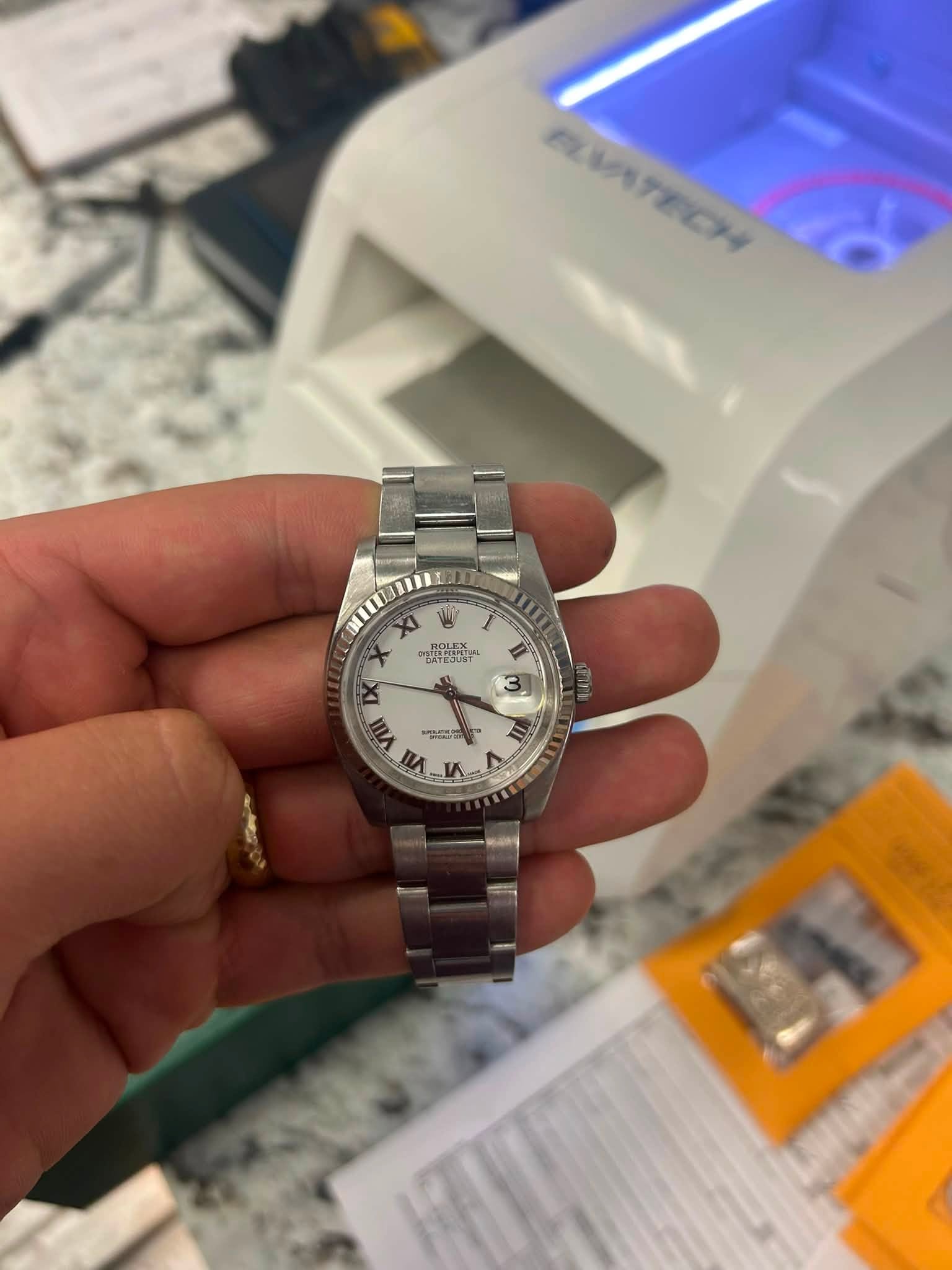 May be an image of wrist watch and text