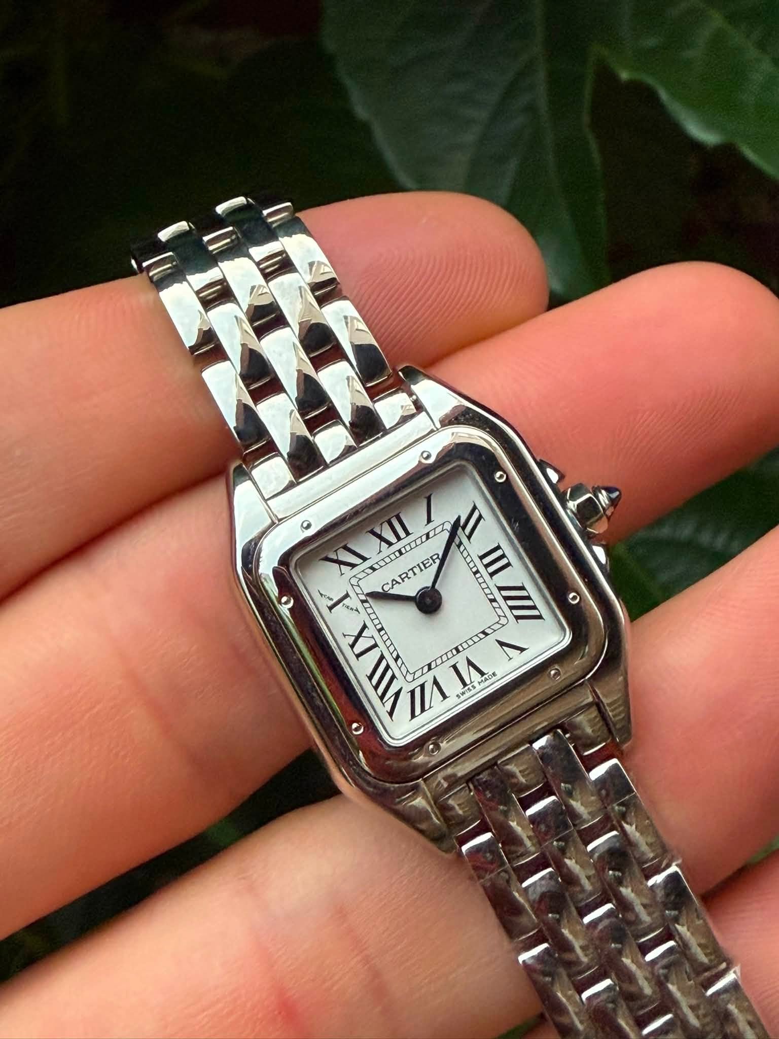 May be an image of wrist watch and text
