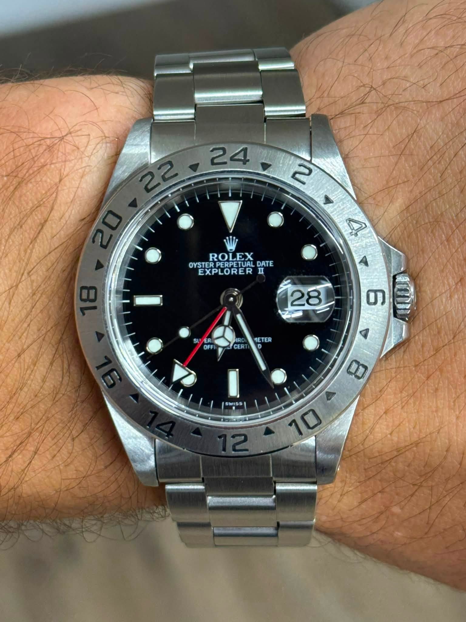 May be an image of wrist watch and text that says ' ROLEX DATE OYSTER OYSTERPERPETUAL EXPLORER II II 4 28 OF CER 1ETER ግ በጣለ I 8 三 FE OL'