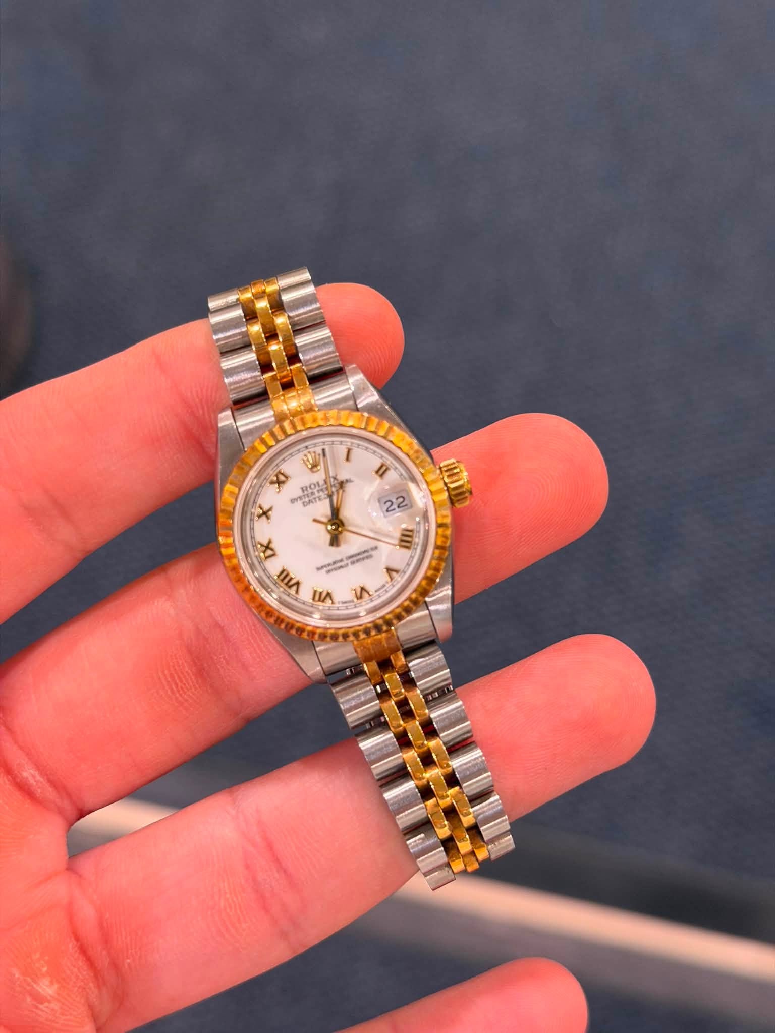 May be an image of wrist watch and text