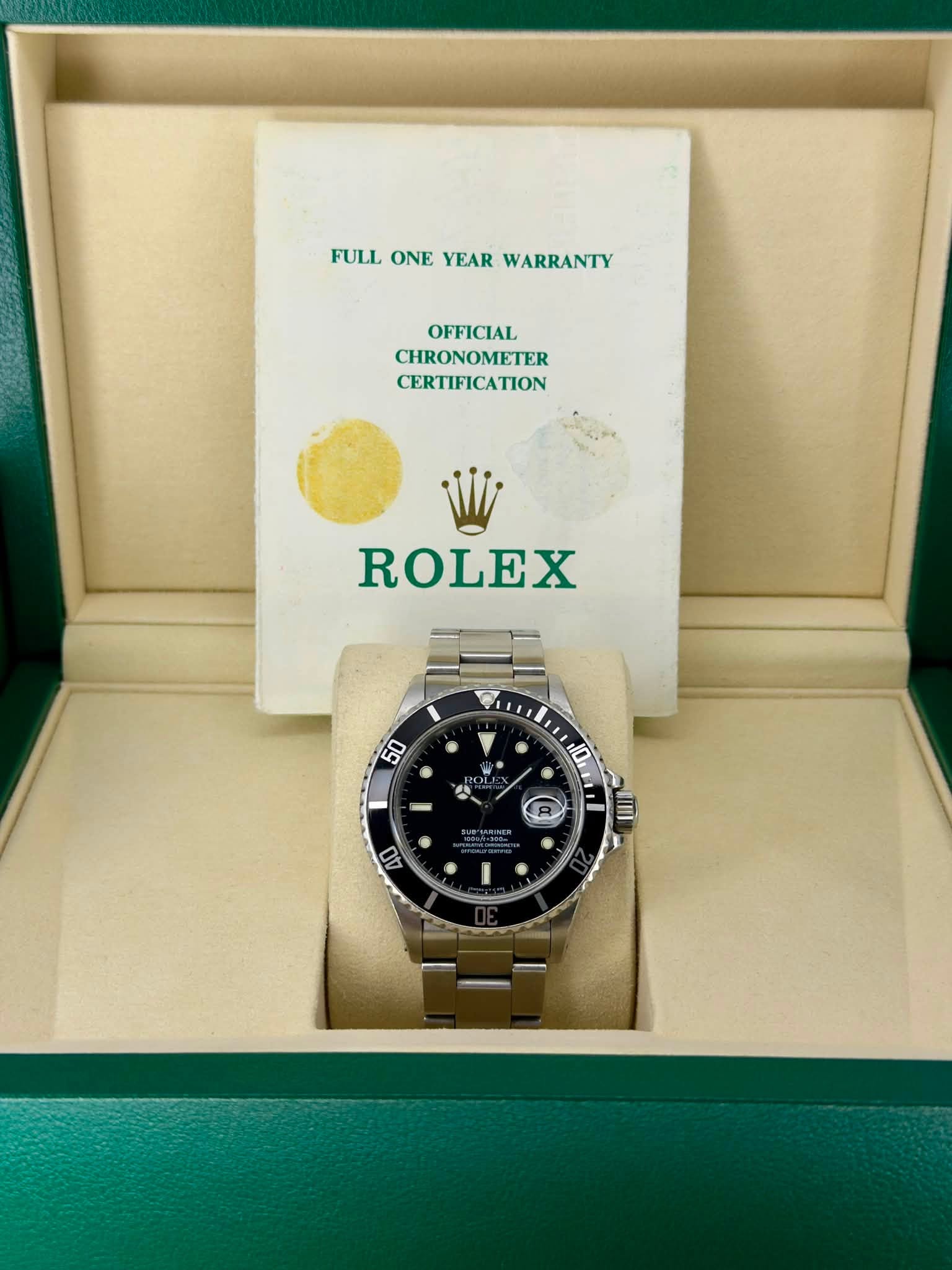 May be an image of wrist watch and text that says 'FULL ONE FULLONEVEARWARRANTY YEAR WARRANTY OFFICIAL CHRONOMETER CERTIFICATION ROLEX ហី W Py • ® R A 10 W il I 40 1'
