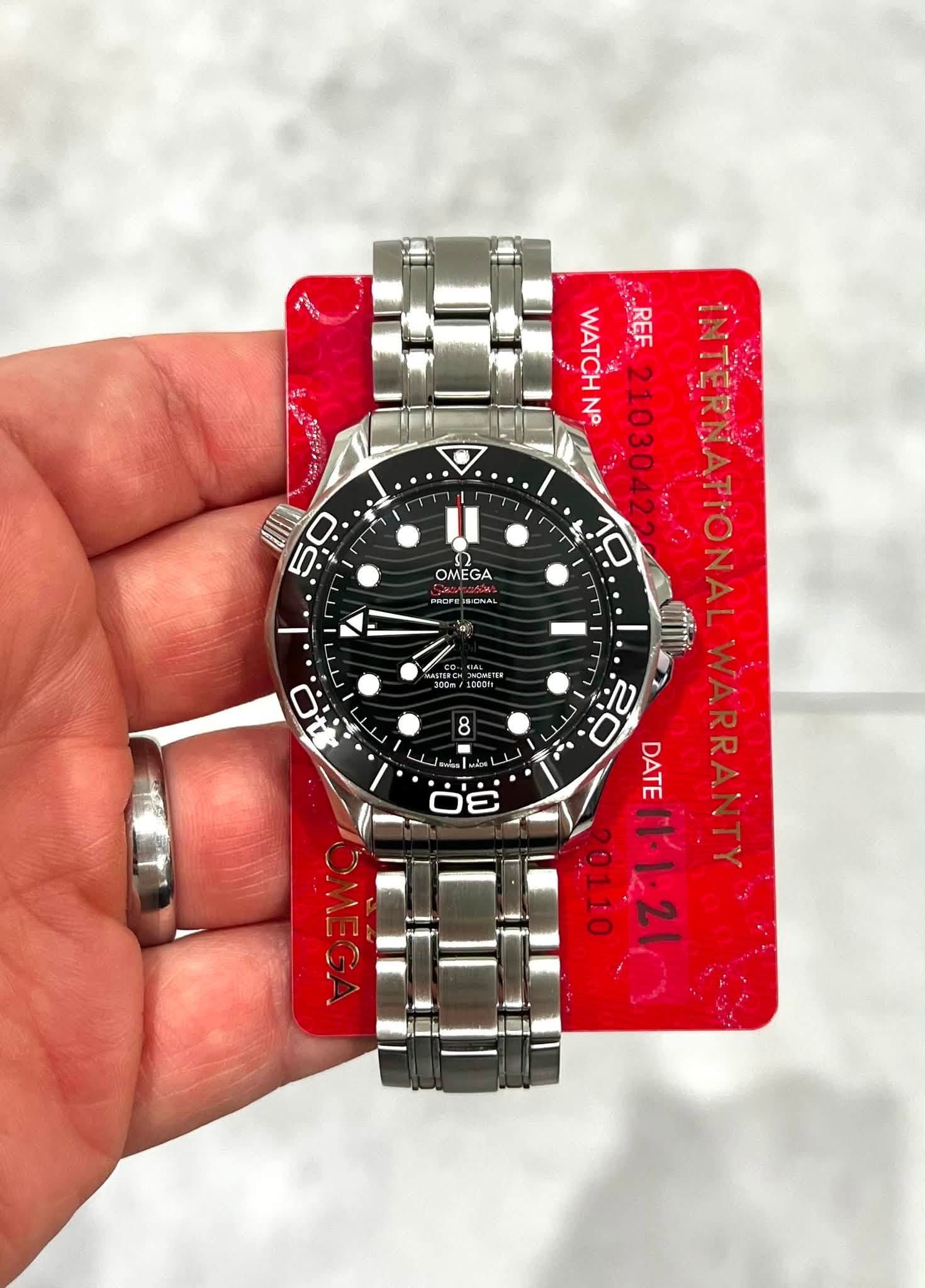 May be an image of wrist watch and text that says 'بف O ! OMEGA POOP PROFE RIDNAL И6TBPOH TRONOIGHETIR ONGMETER /1000H WATCHN N° 21030422 INTERNATIONAL WATCH REF 10 20 DATE…