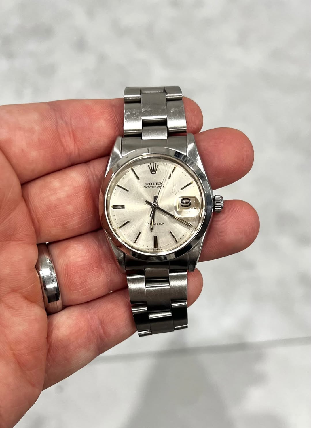 May be an image of wrist watch and text